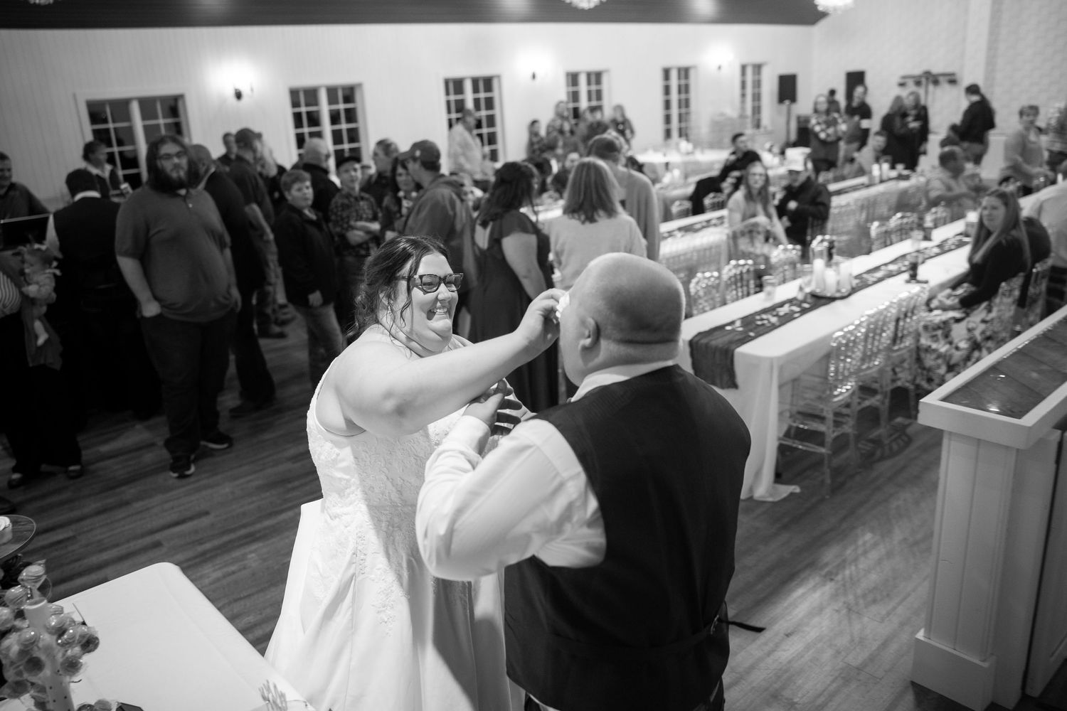 Black and white photo of wedding reception dancing and celebrations.