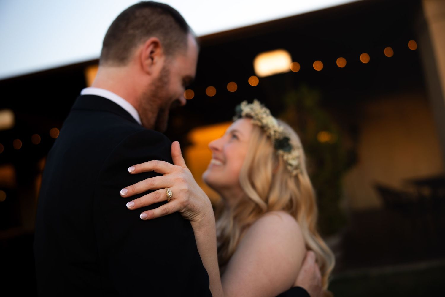 A couple shares an intimate dance moment at their wedding reception.
