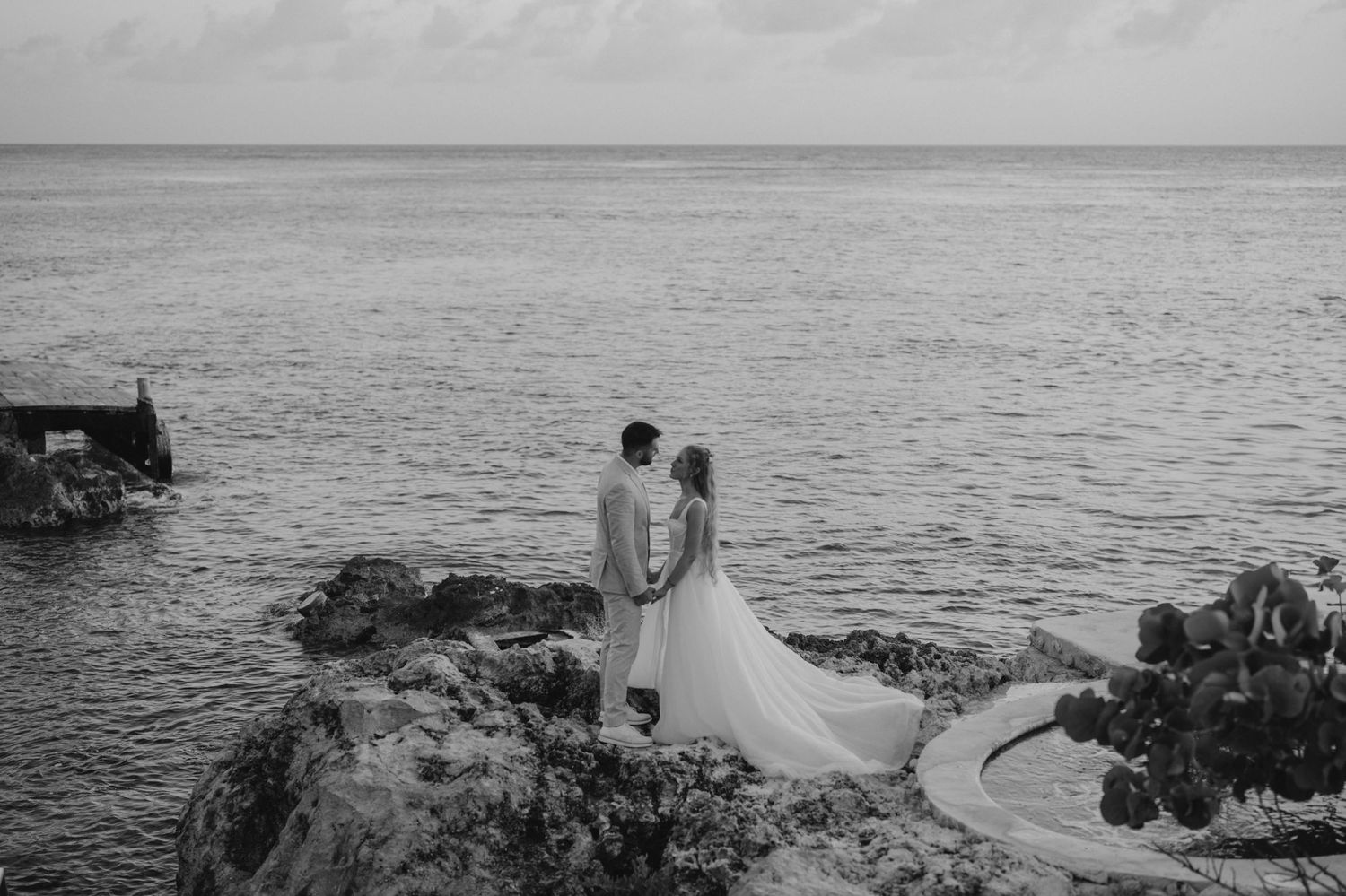 Coastal wedding photography sequence with dramatic ocean views and rocky shoreline.