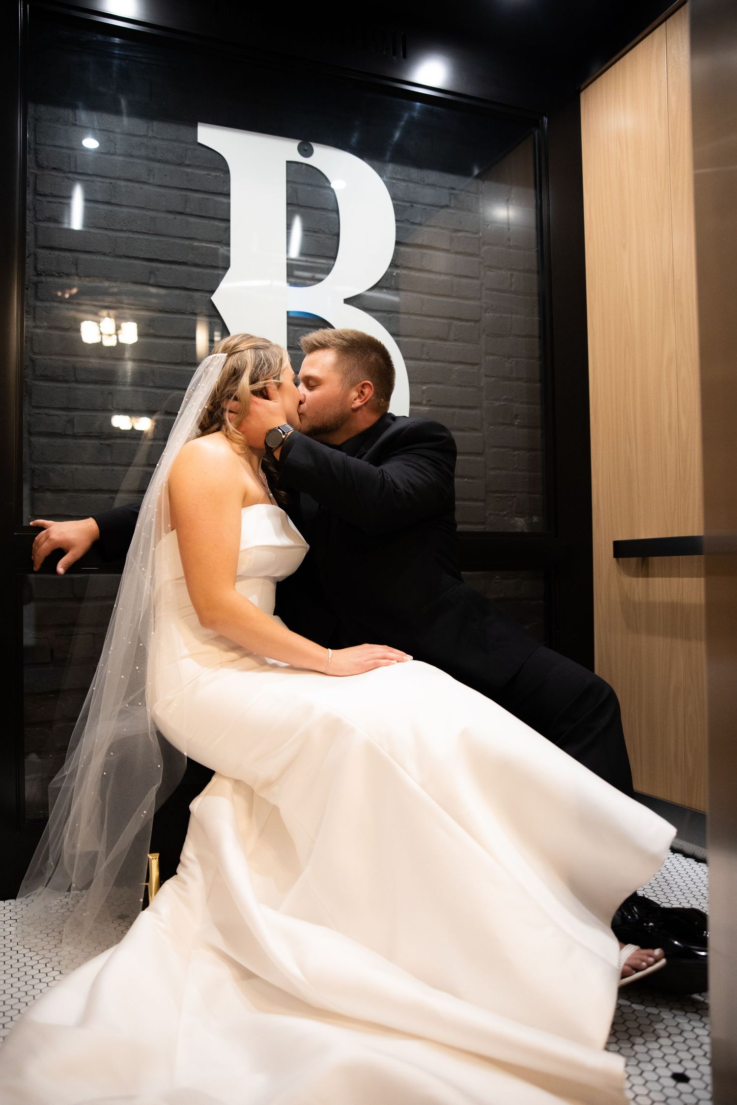 Dramatic wedding dance poses captured against modern black and white interior.
