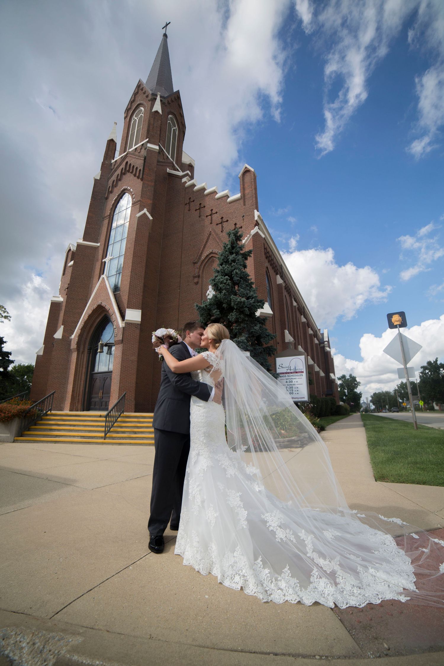 Gothic church exterior with dramatic stairs and flowing bridal veil in foreground.