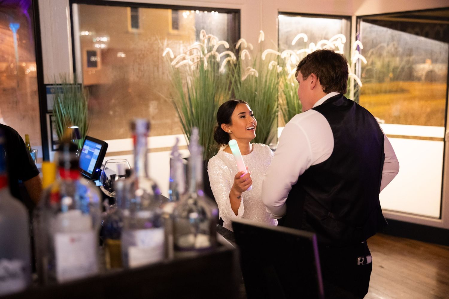 A candid moment at the reception bar showing guests interacting.