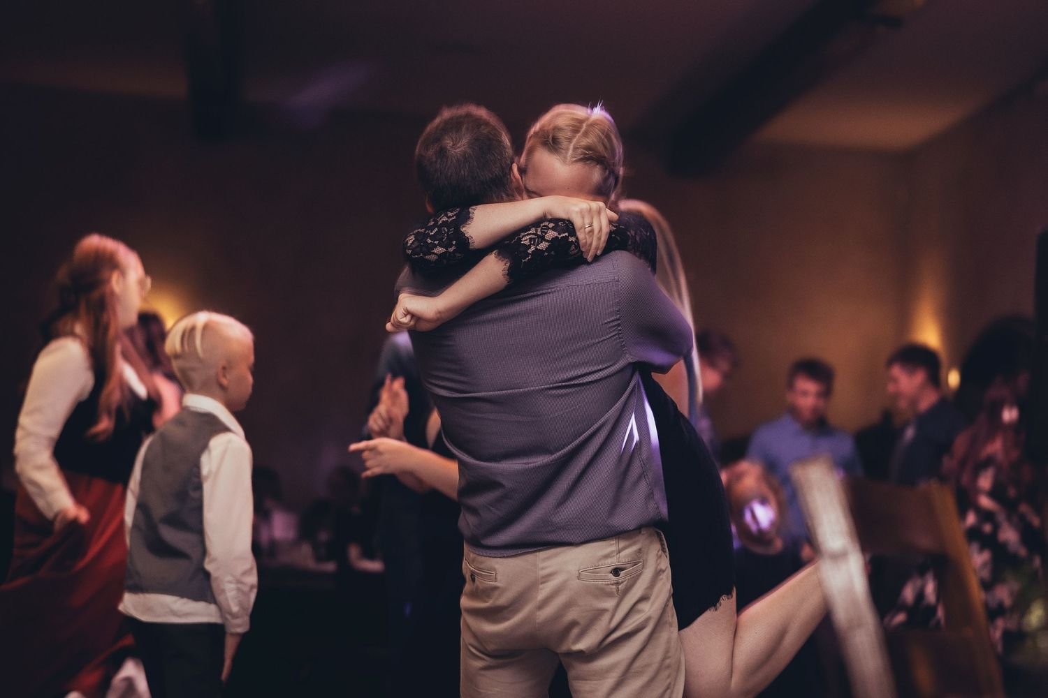 Couples sharing romantic dances during an evening wedding reception.