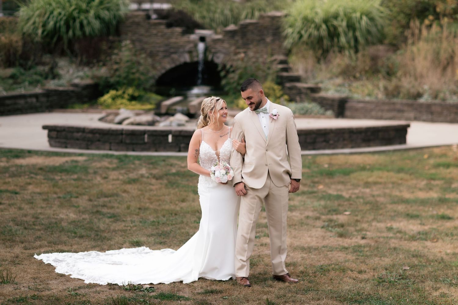 Wedding photography session in a scenic outdoor garden setting with lush greenery.