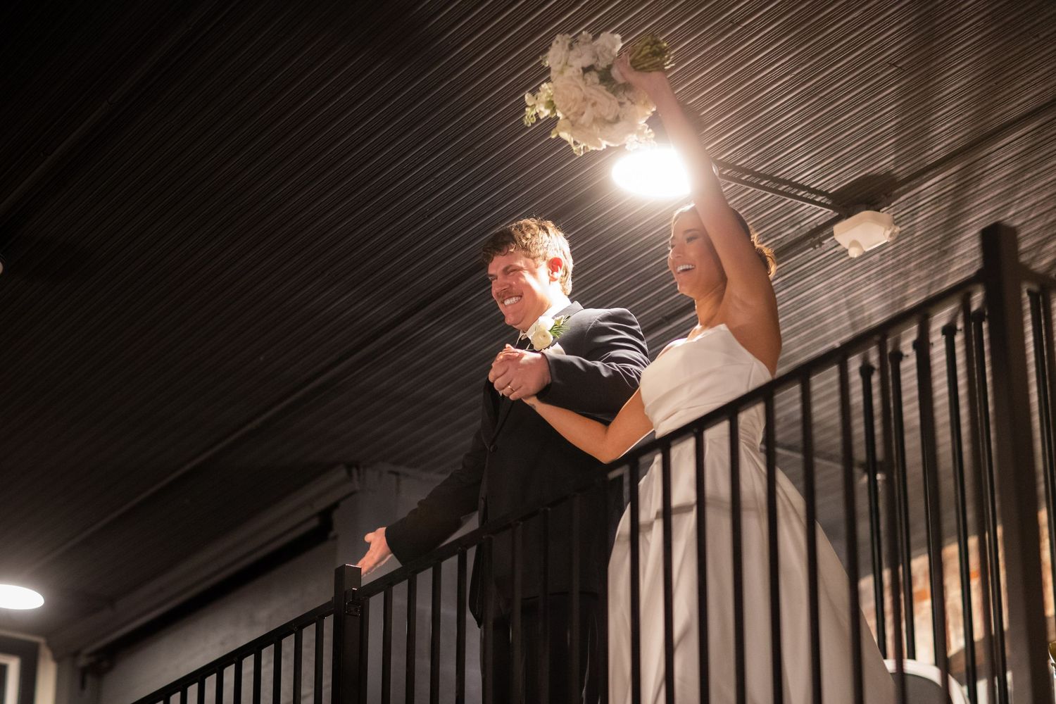 Dramatic low-angle shot of a staircase with dark railings in an event venue.