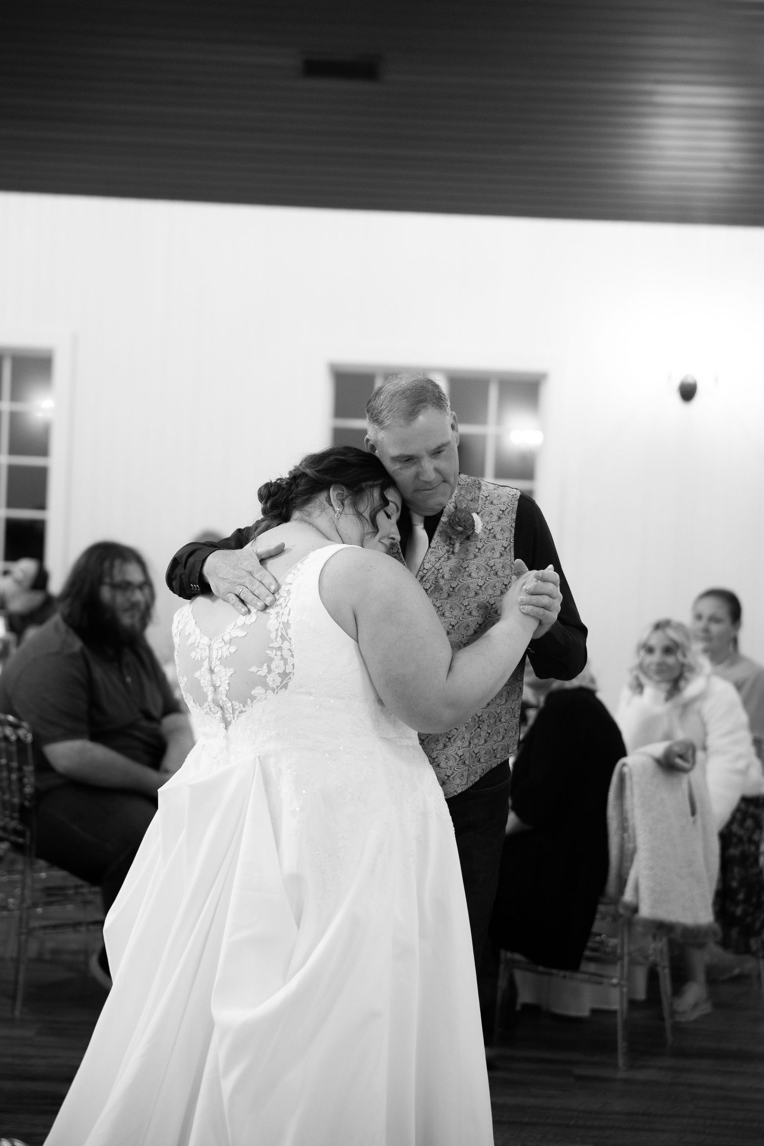 A series of black and white wedding photos showing intimate moments during a first dance at a reception.