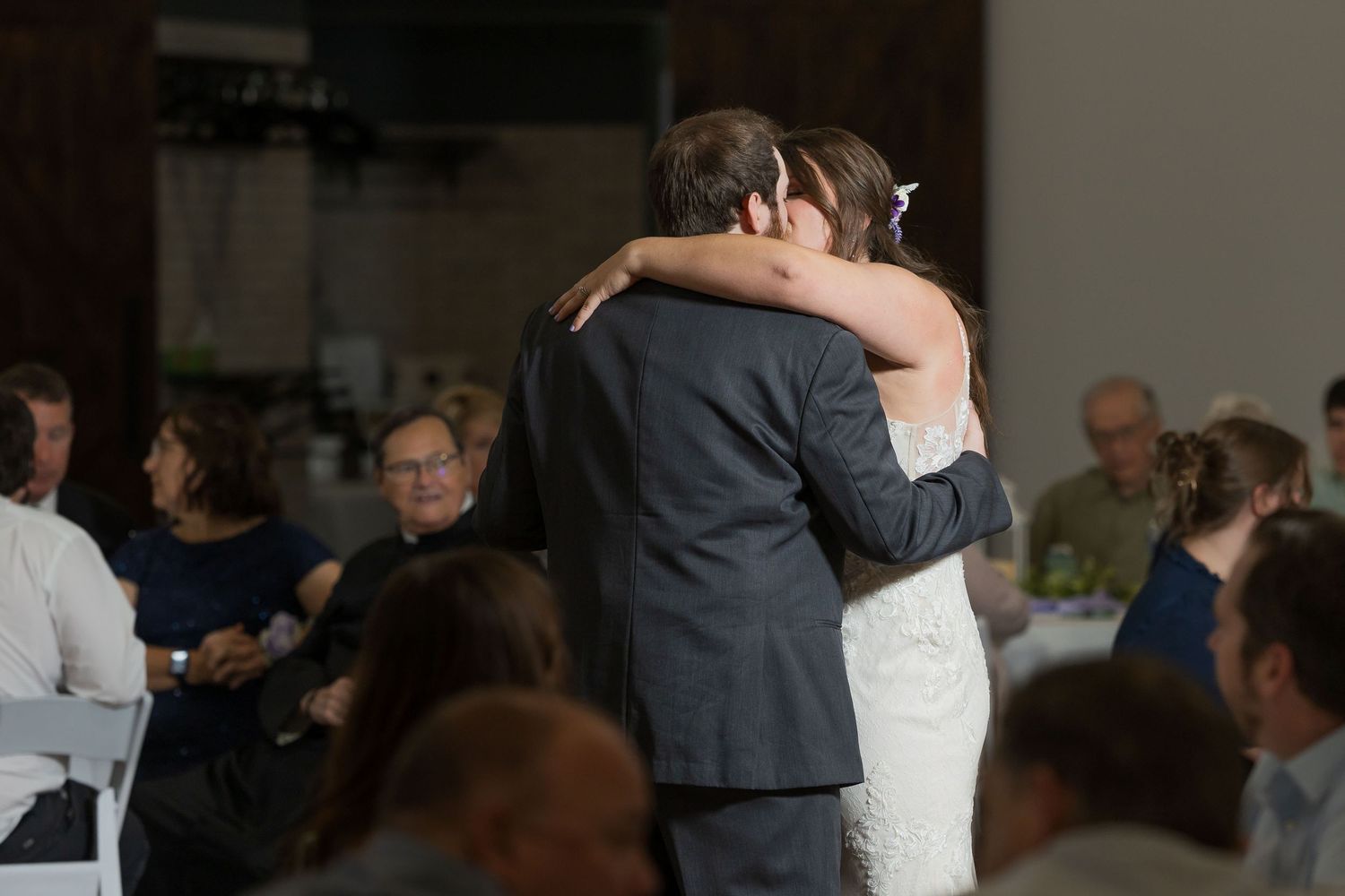 Bride and groom share their first dance at wedding reception.