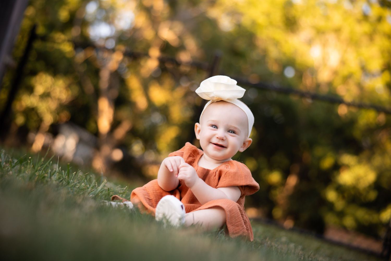 Dreamy sunset portrait of child in coral colored outfit.