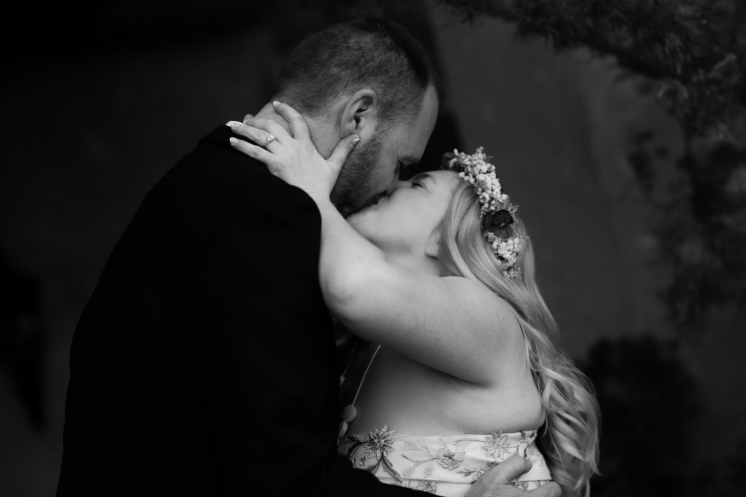 Romantic black and white portrait of a couple sharing an intimate moment at their wedding.