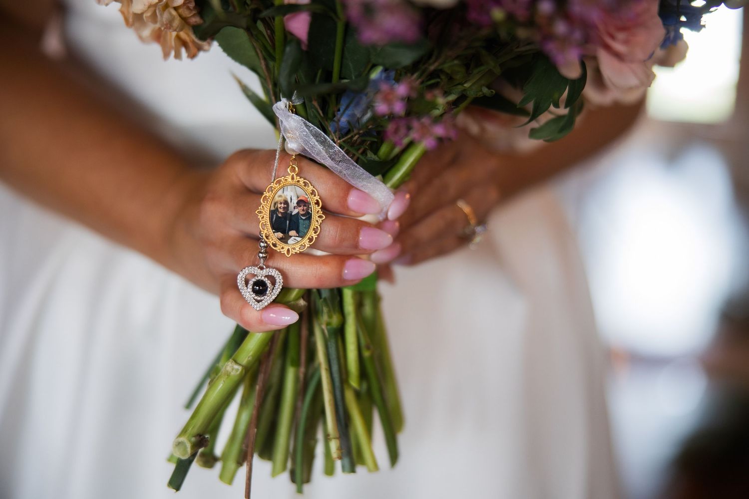 Close-up details of bridal bouquet with pink and purple flowers.