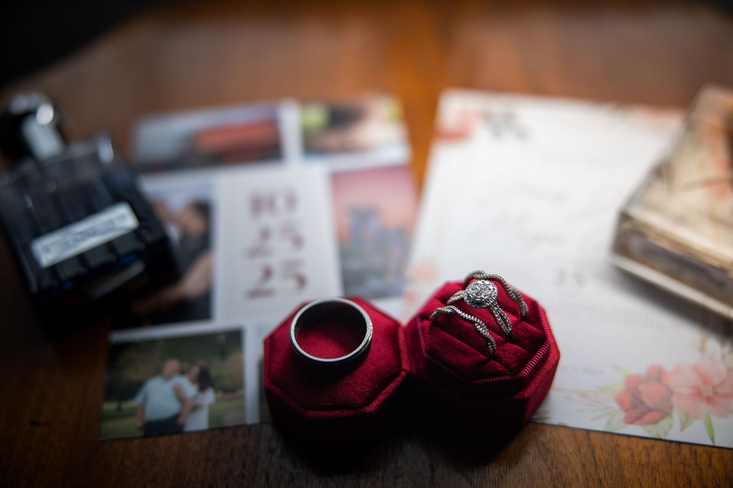 Wedding rings rest on a dark surface with soft lighting creating an intimate atmosphere.