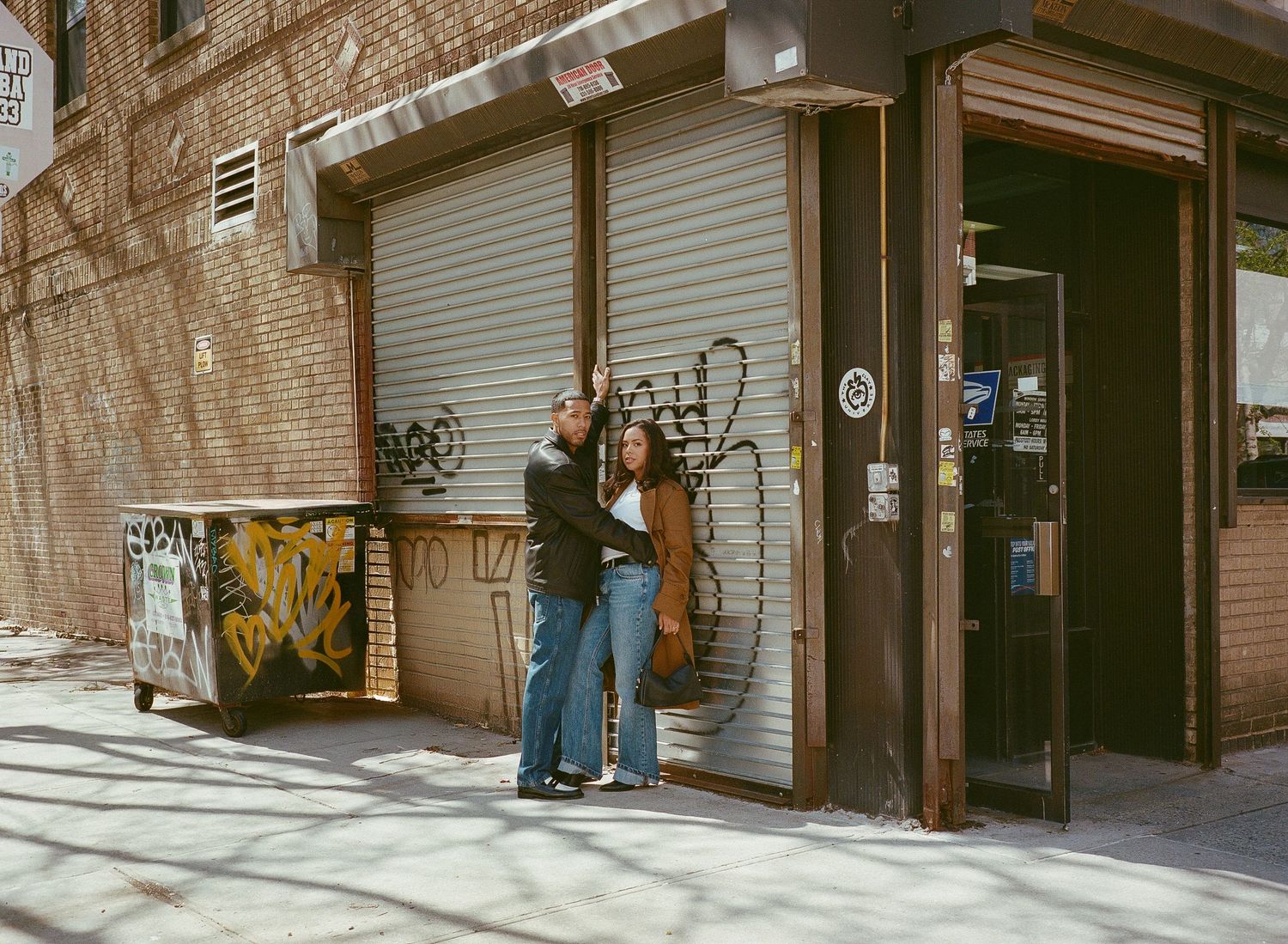 A sequence of black and white street photographs showing people walking past closed storefronts and brick buildings.