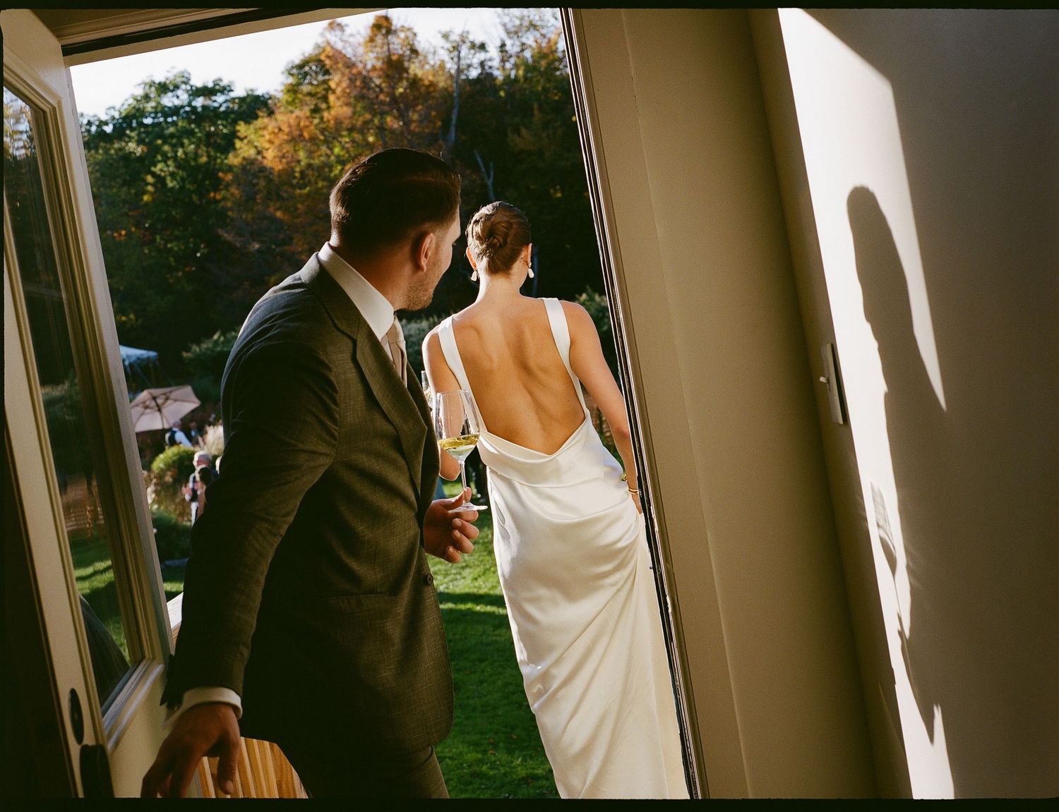 Sunlit corridor with large windows and white walls creating dramatic shadows on film.