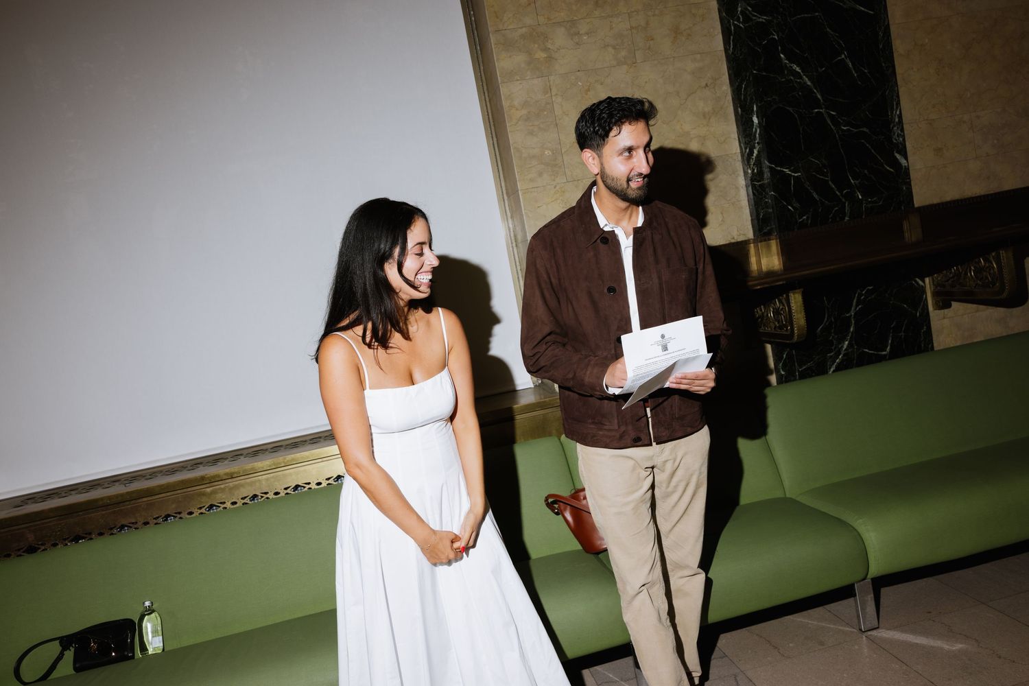 A wedding couple stands together in formal attire during their special day celebration.