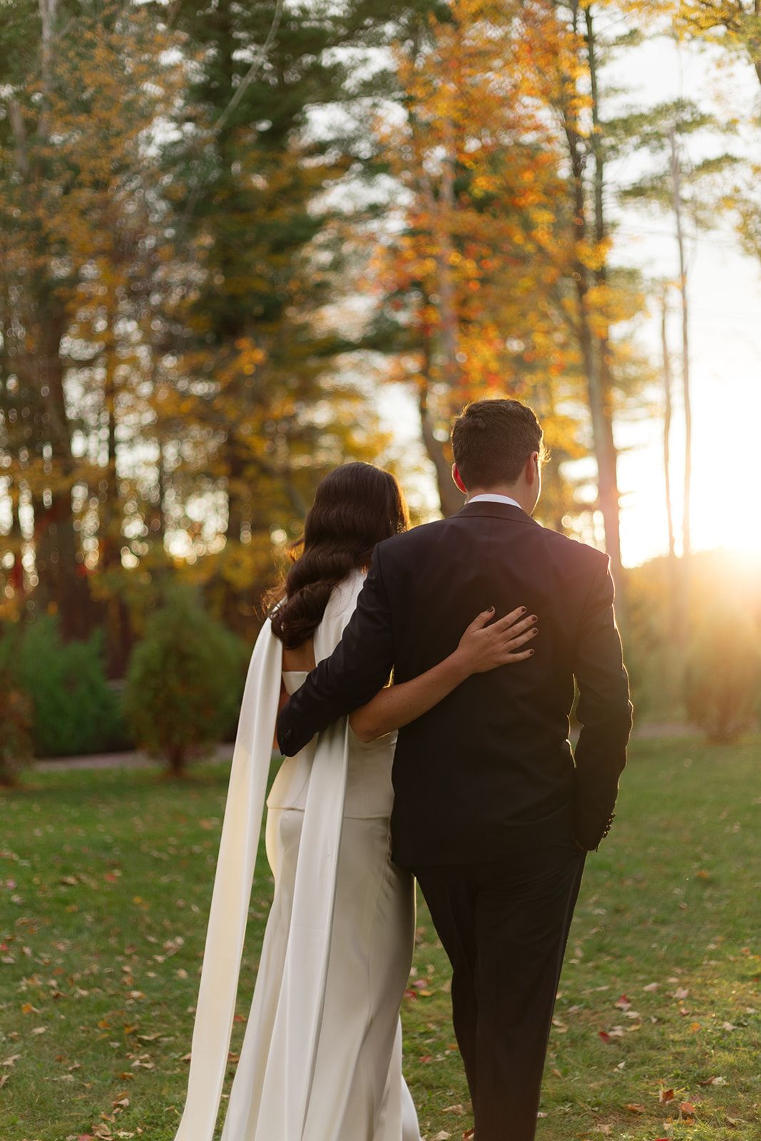 Artistic wedding photo sequence at sunset showing couple leaning against white doors in autumn forest setting.