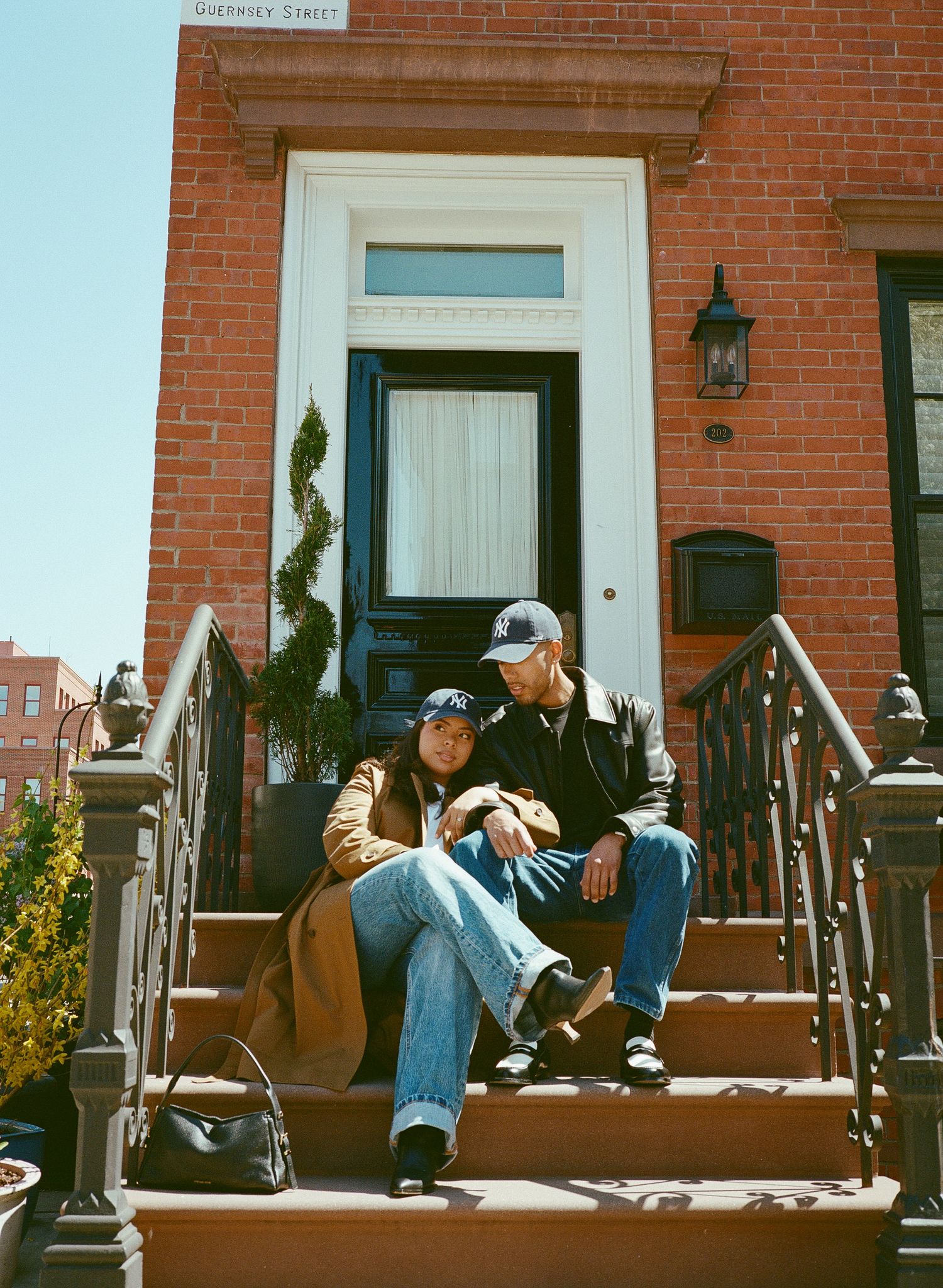 Three connected images show people sitting on red brick steps in casual clothing on a sunny day.