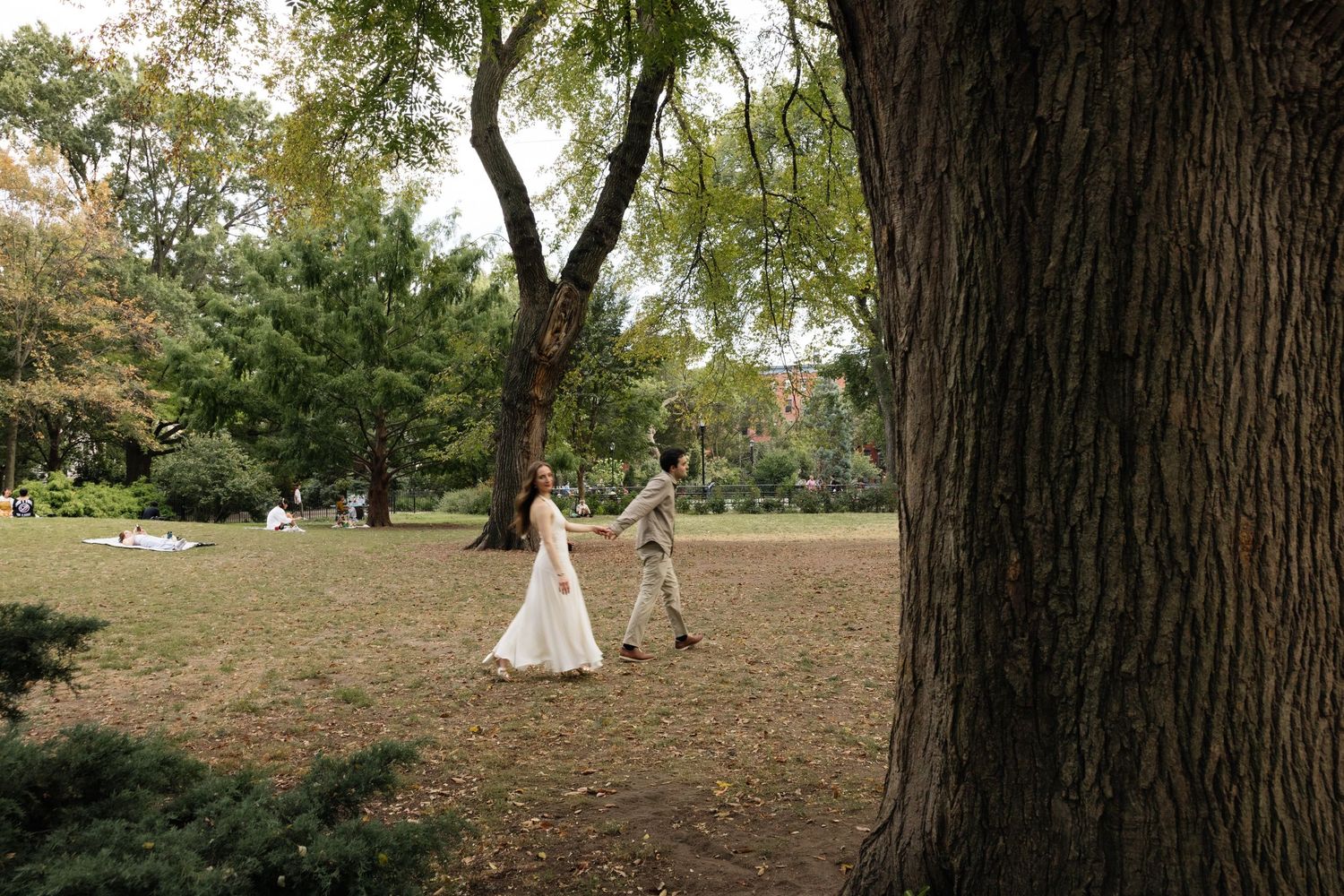 A wedding ceremony setup in a wooded outdoor area with white teepee tents and natural decor.