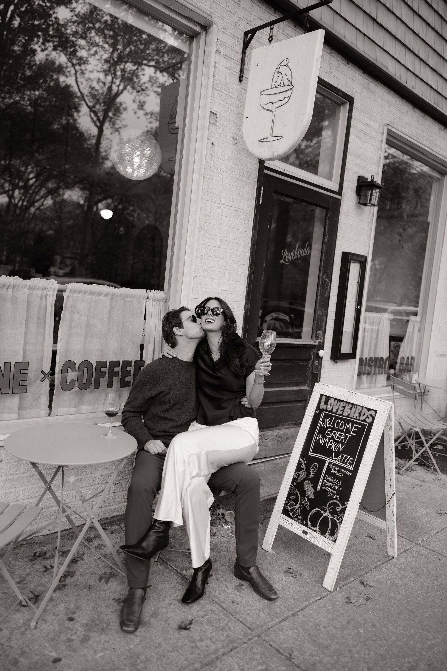 A sequence of black and white photos showing people sitting outside a coffee shop with chalkboard signs and storefront windows.