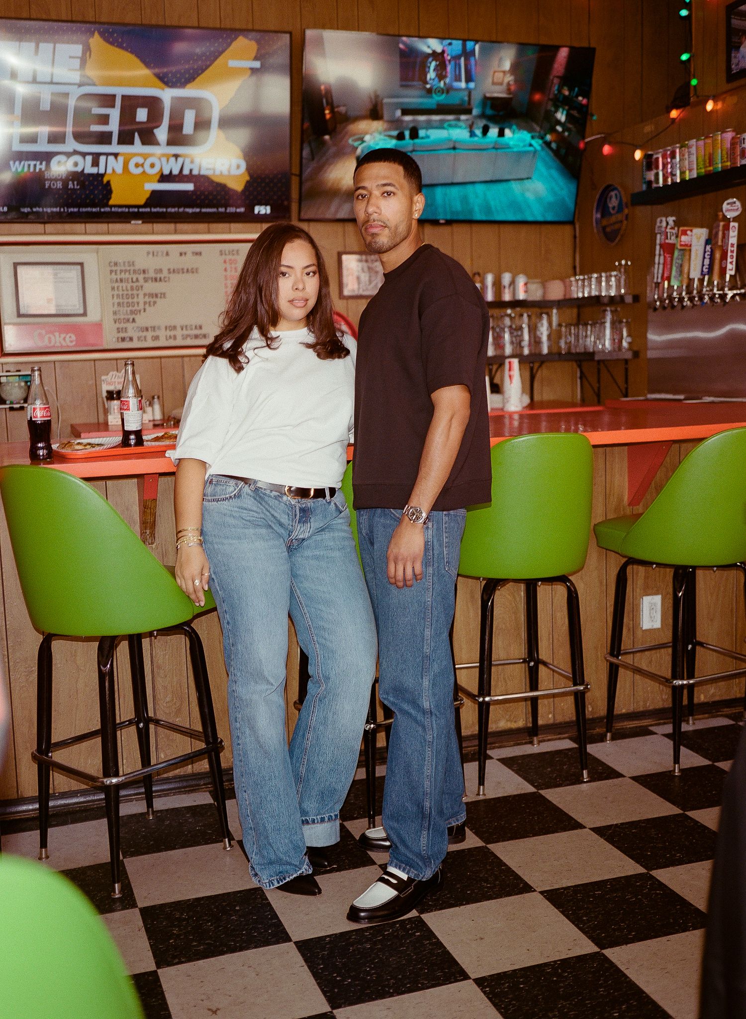 A series of three connected photos showing people sitting at a retro-style diner counter with green barstools and TVs mounted above.