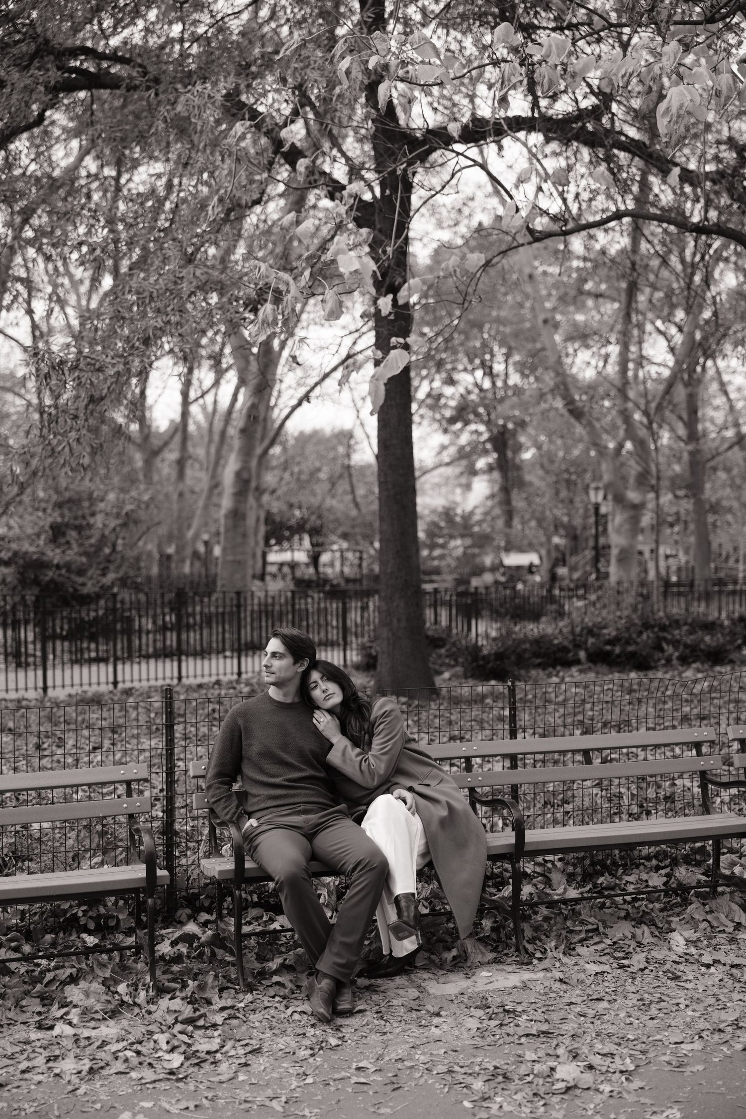 Black and white photo sequence showing a couple sitting on a park bench surrounded by autumn leaves and trees.
