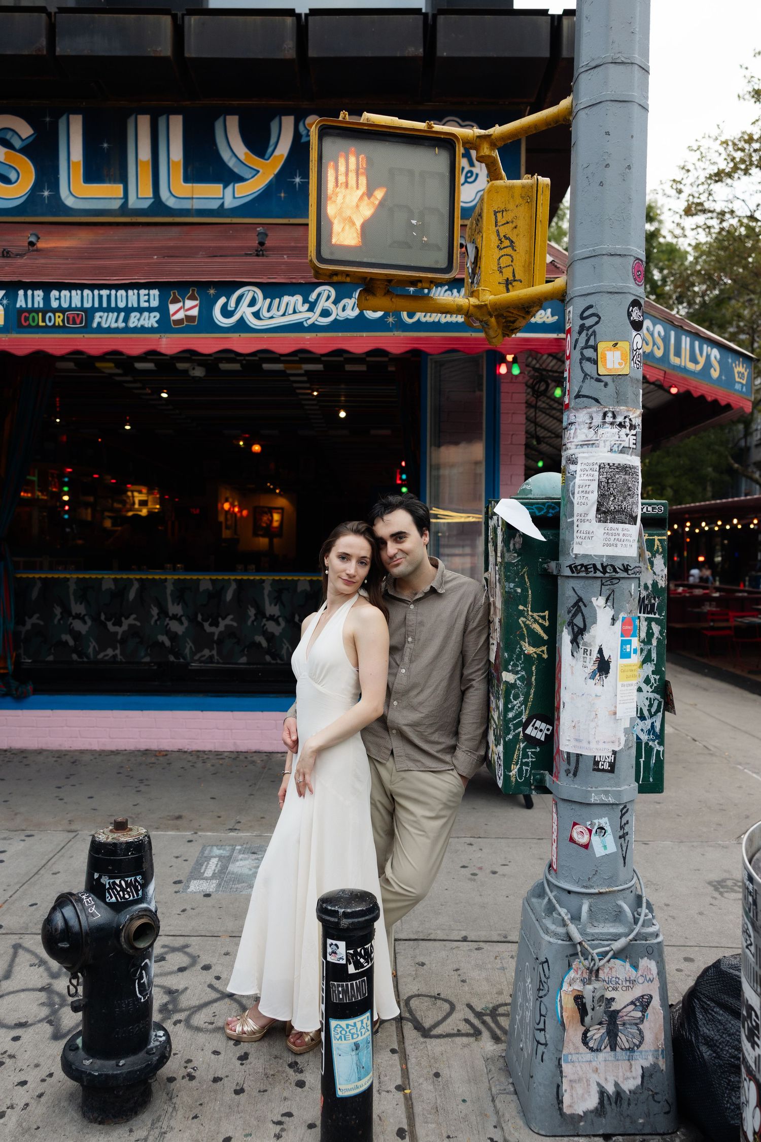 Urban street scene with vintage neon signs and graffiti-covered walls in a city setting.