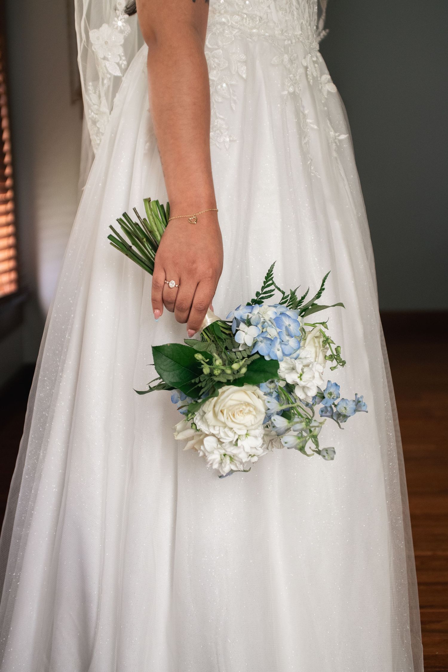 Cinematic wedding detail photo of bridal bouquet and jewelry at Willow Creek Farm in Urbana Illinois by Urbana Ever After Photography