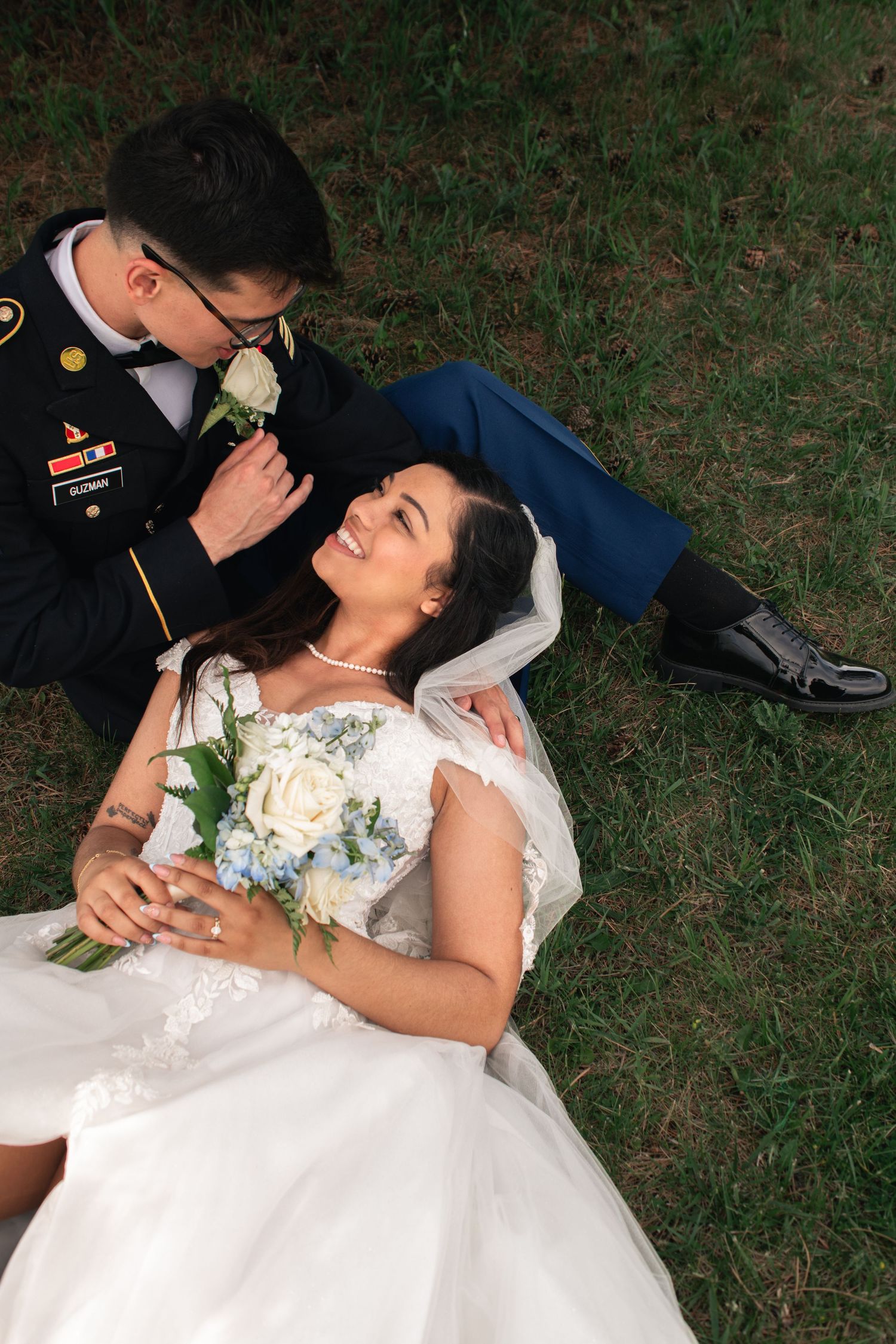 Couple sitting on the grass looking at each other after wedding at Willow Creek Farm in Urbana, Illinois by Urbana Ever After Photography