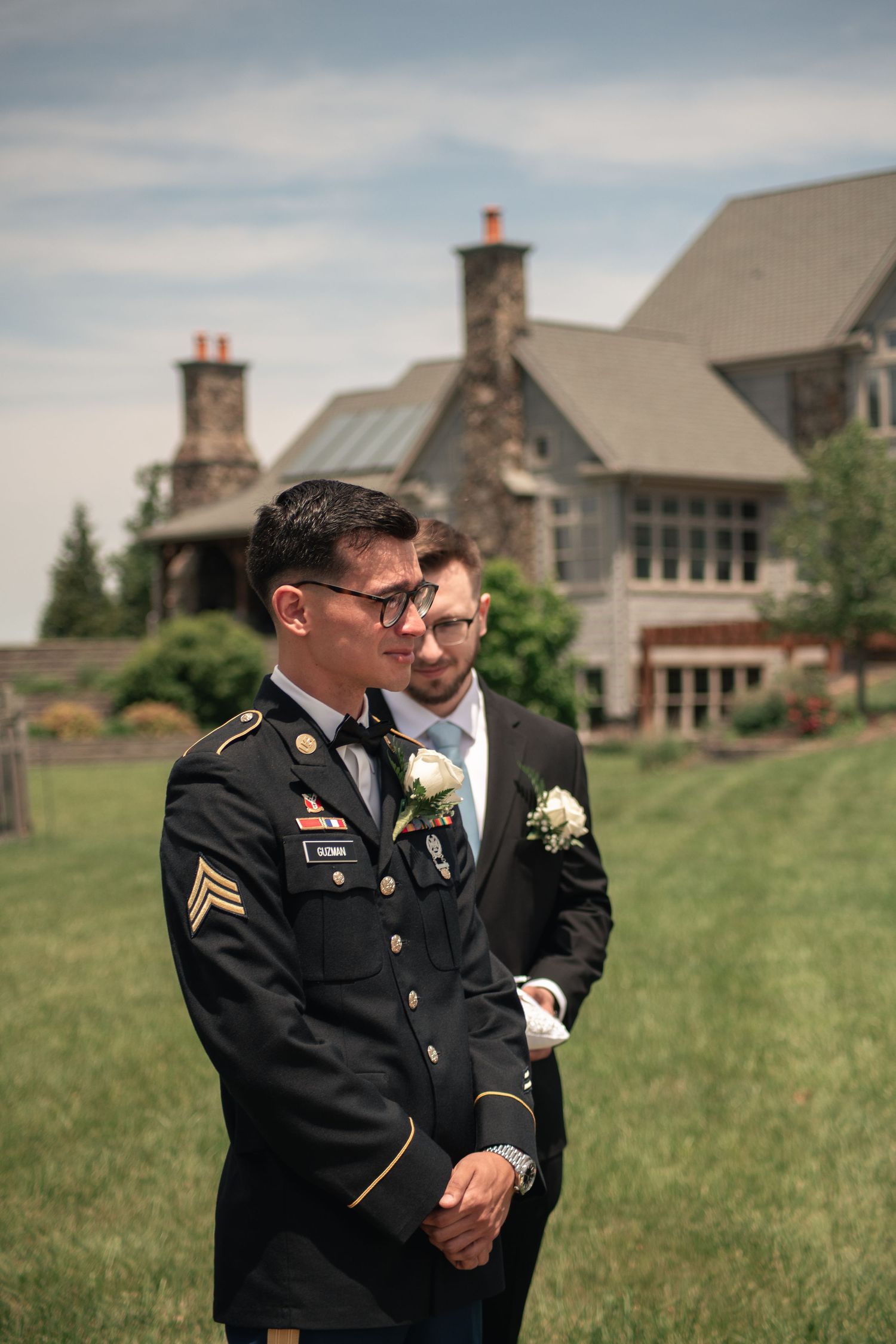 Cinematic wedding ceremony photo of groom's reaction to bride walking down the isle in military wedding at Willow Creek Farm in Urbana, IL