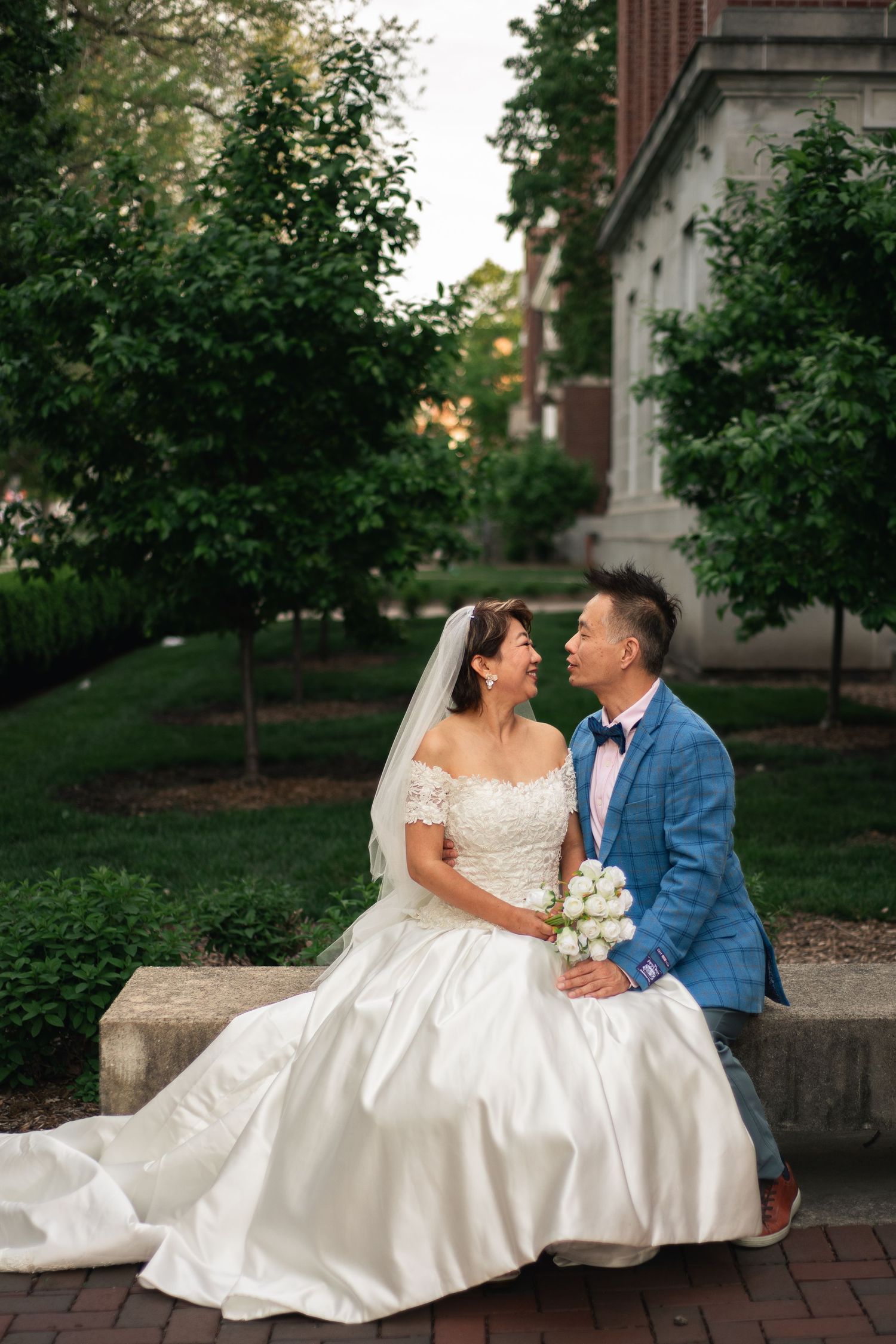 Couple in wedding attire for a golden hour wedding portrait session at the Main Quad on the University of Illinois Champaign-Urbana Campus