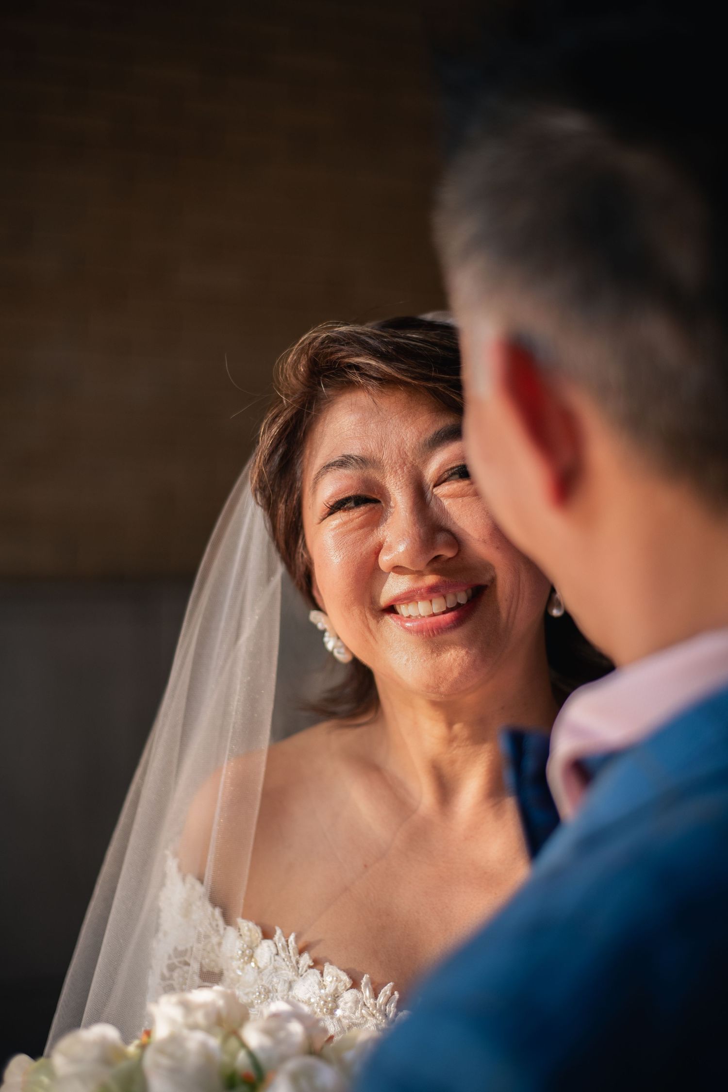 Couple looking at each other in warm cinematic style wedding styled anniversary session on the University of Illinois main quad in Champaign
