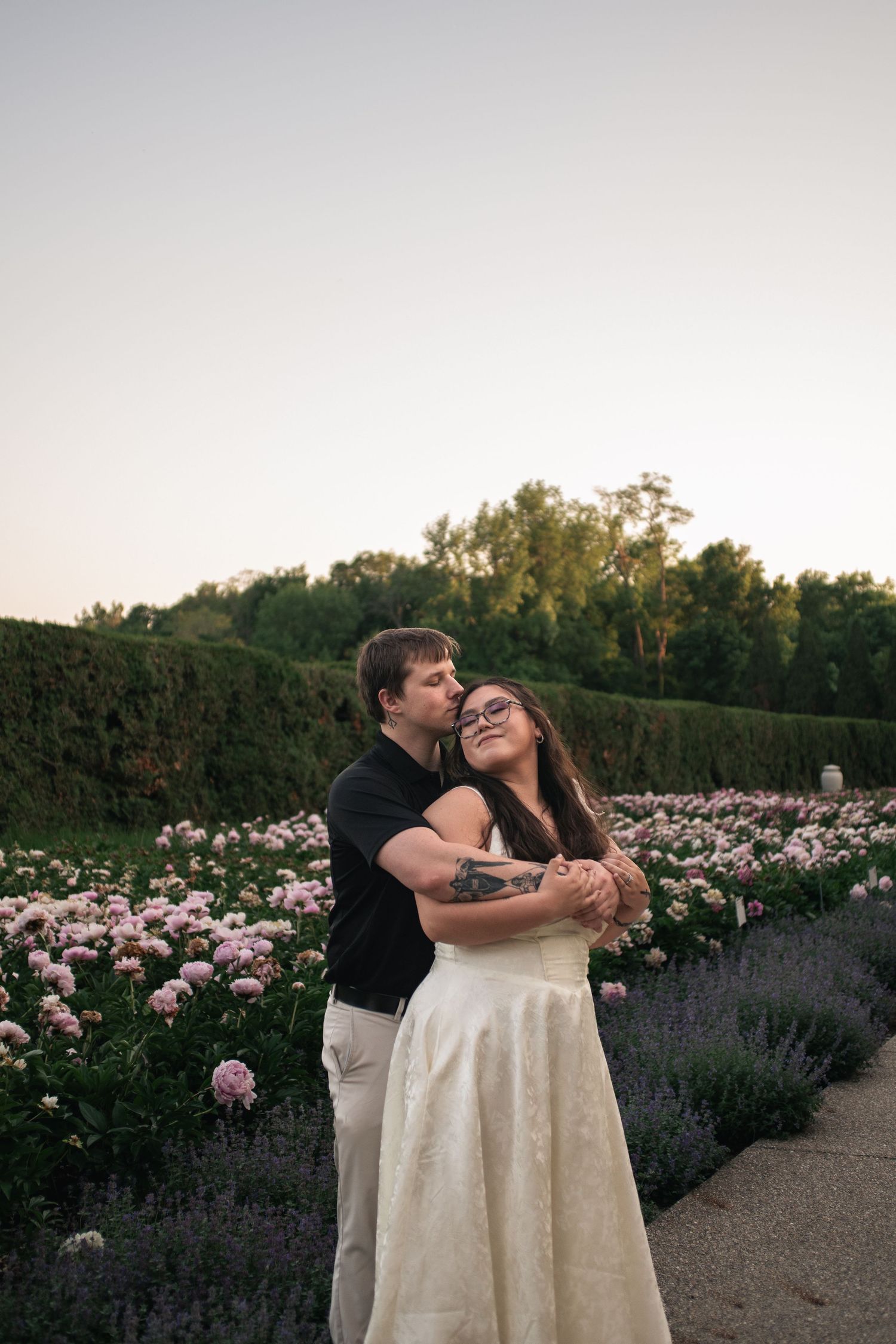 Golden hour engagement photo taken in the peony garden at Allerton Park and Retreat Center in Monticello IL by Urbana Ever After Photography