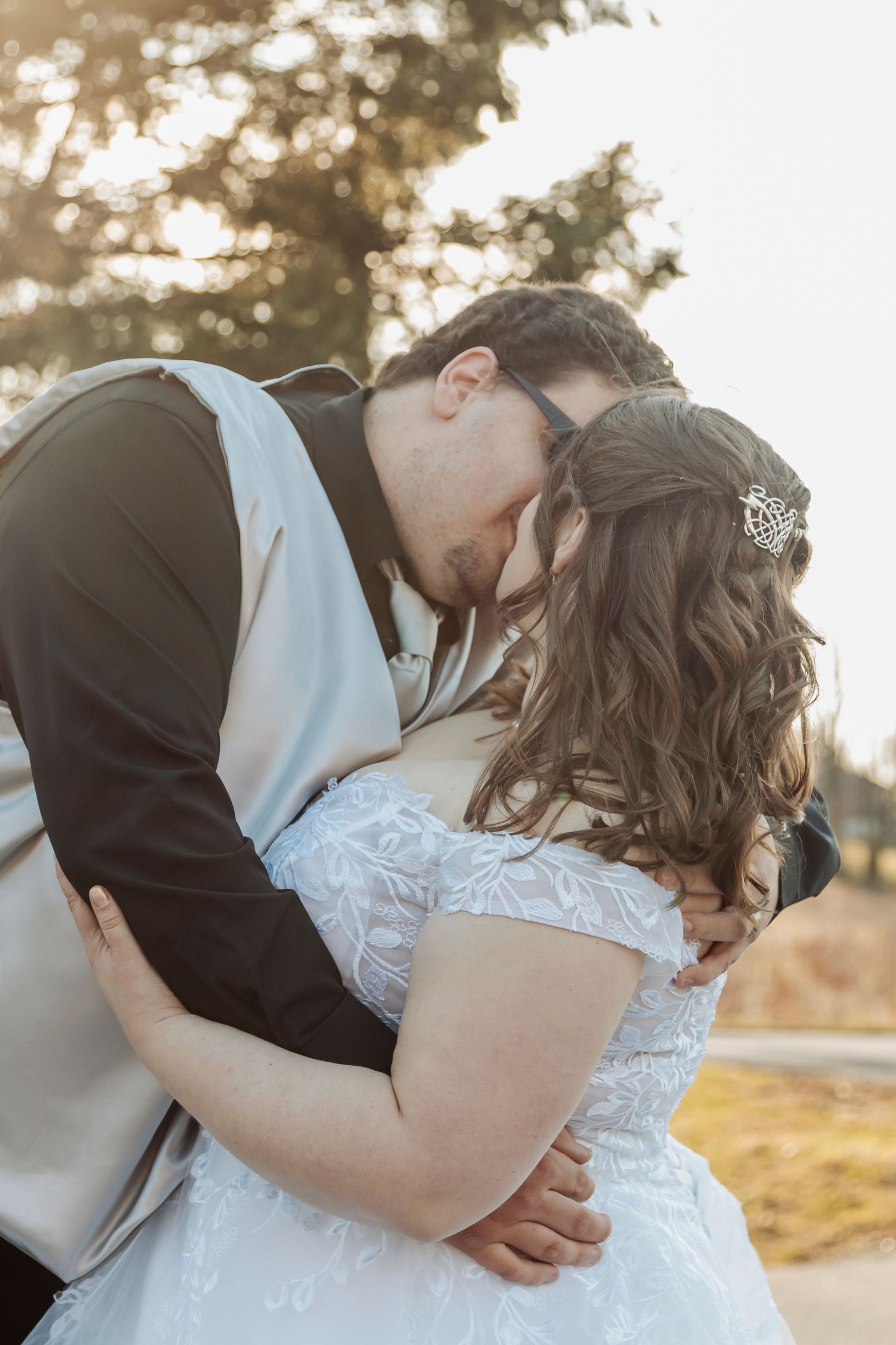 Intimate wedding couple shares romantic moments during golden hour portrait session.