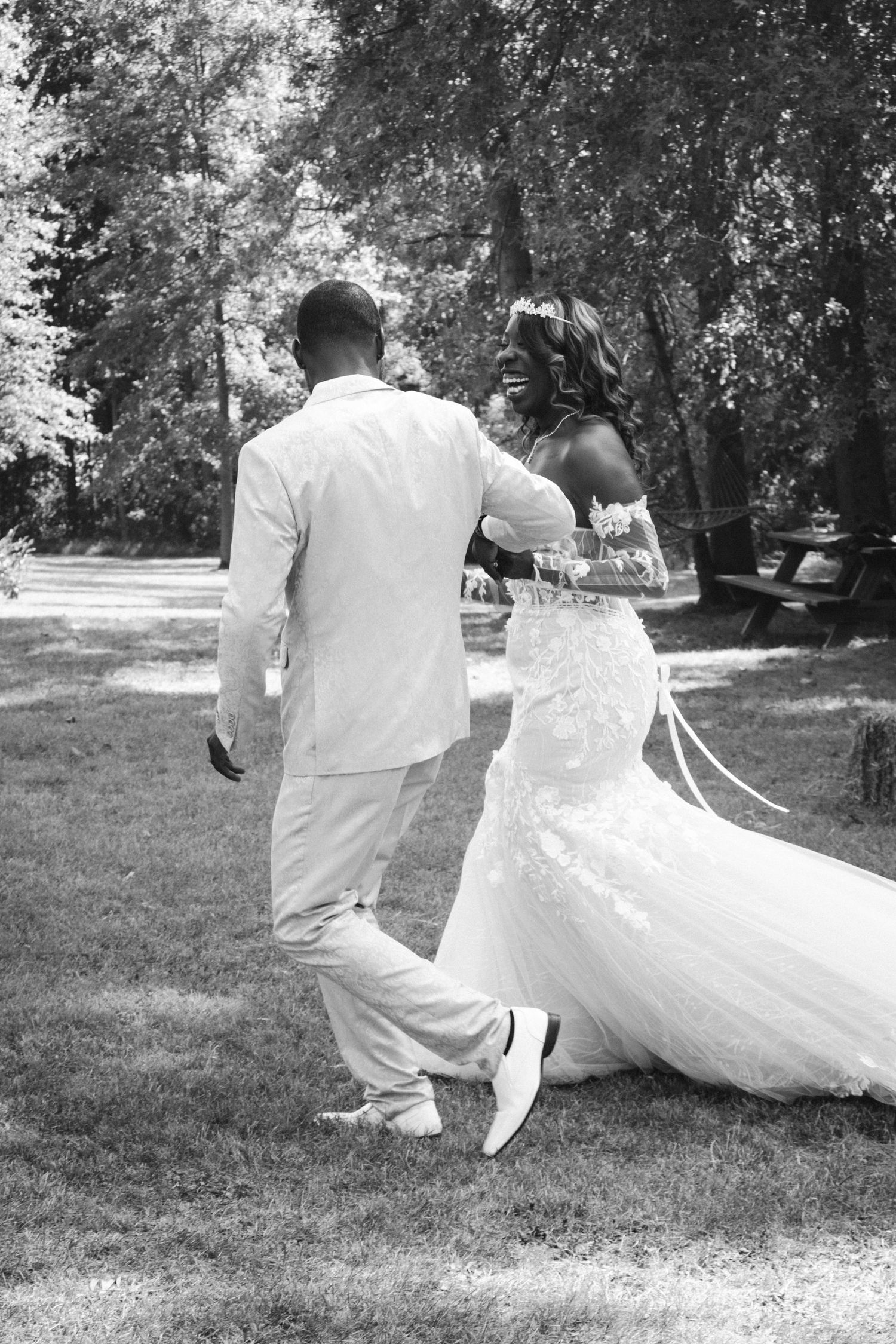 Black and white photo sequence of couple dancing and twirling in formal attire outdoors.