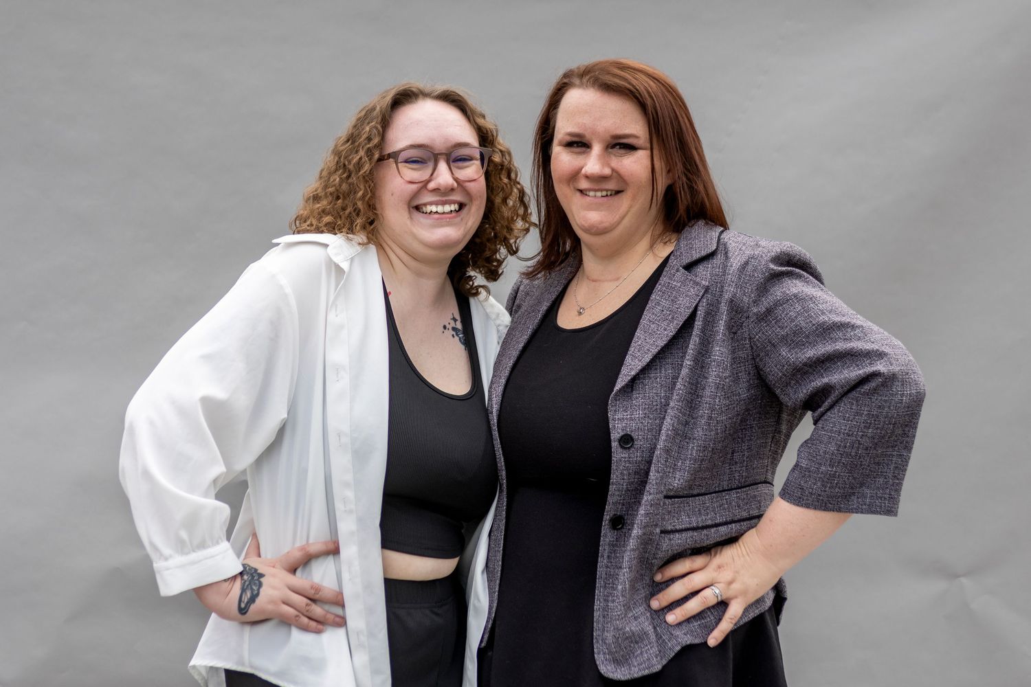 Group portrait session showing casual interactions and laughter against gray studio background.