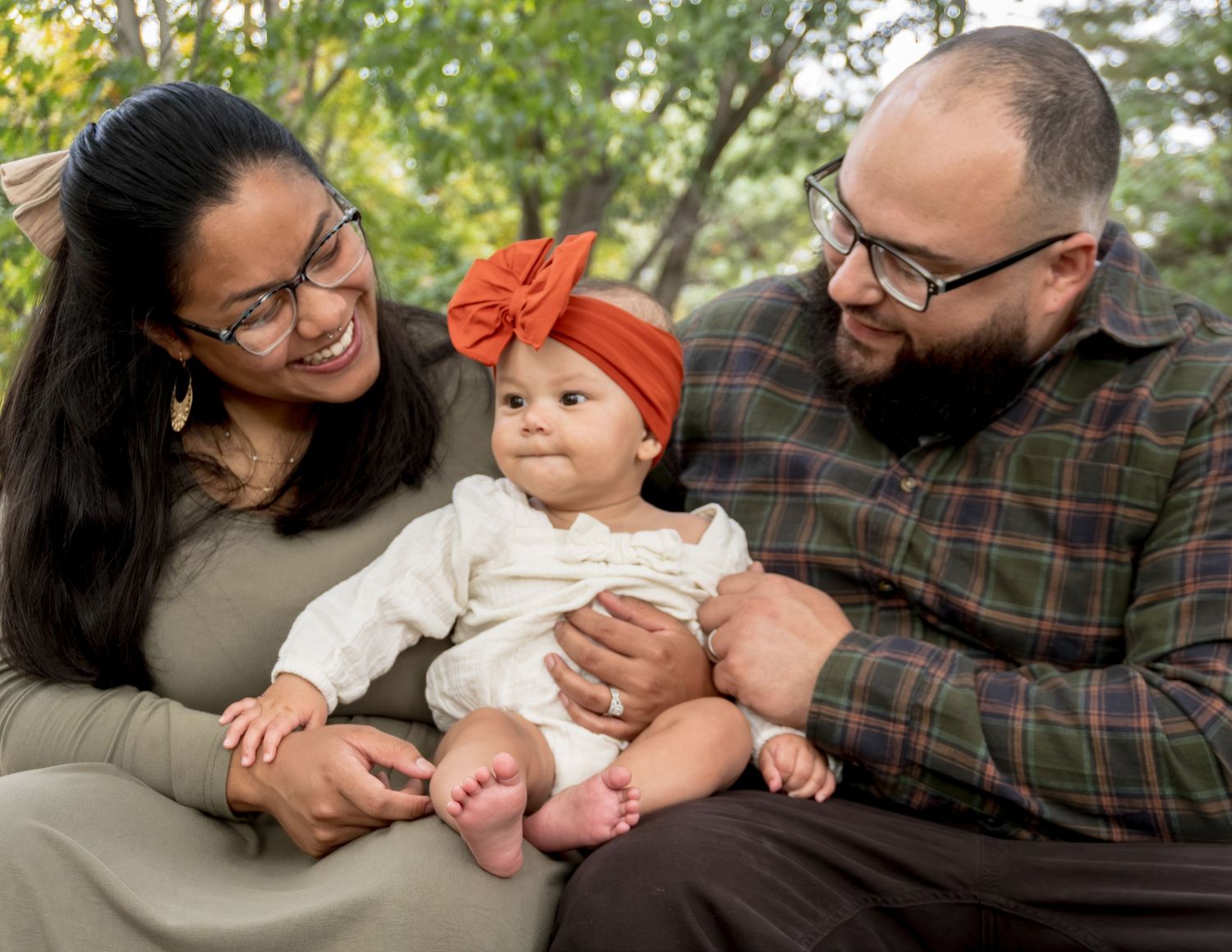 Family shares tender moments during an outdoor autumn photo session.