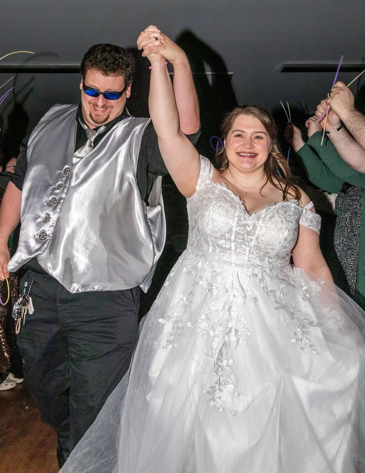 Wedding couple dancing and celebrating on a dark dance floor.