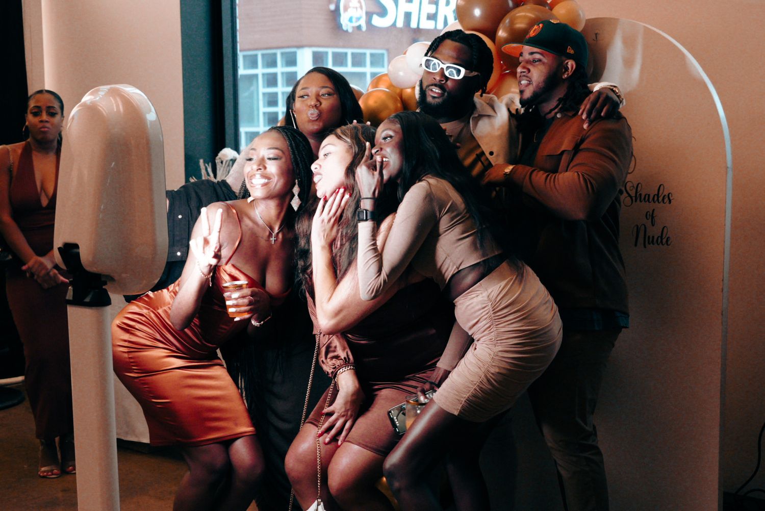 A group of people enjoying a lively celebration in an indoor venue with warm lighting.