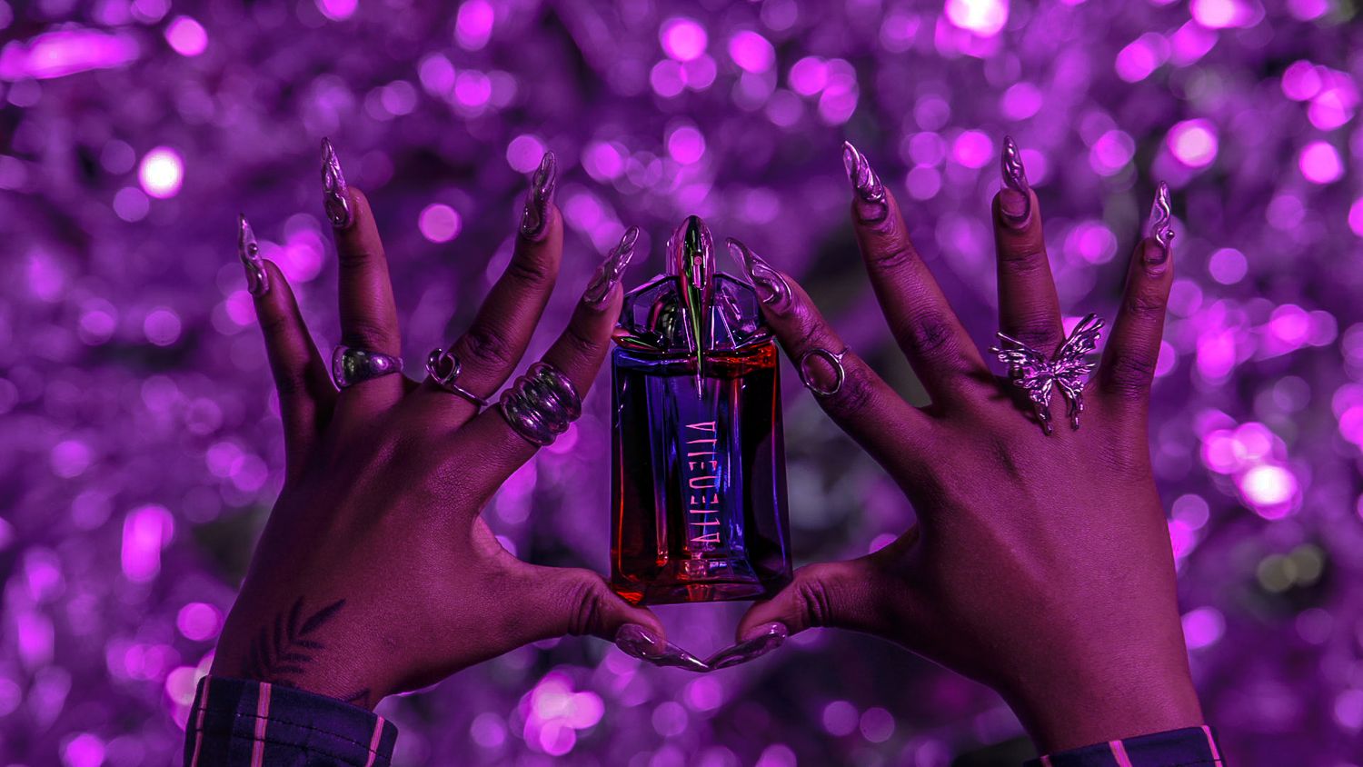 Purple-tinted close-up of hands holding drinks against a bokeh background.