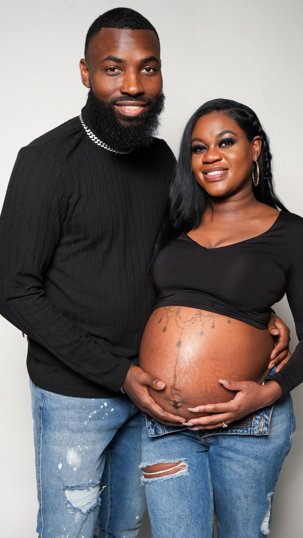 Maternity photoshoot series with couple in black tops and distressed jeans against white background.