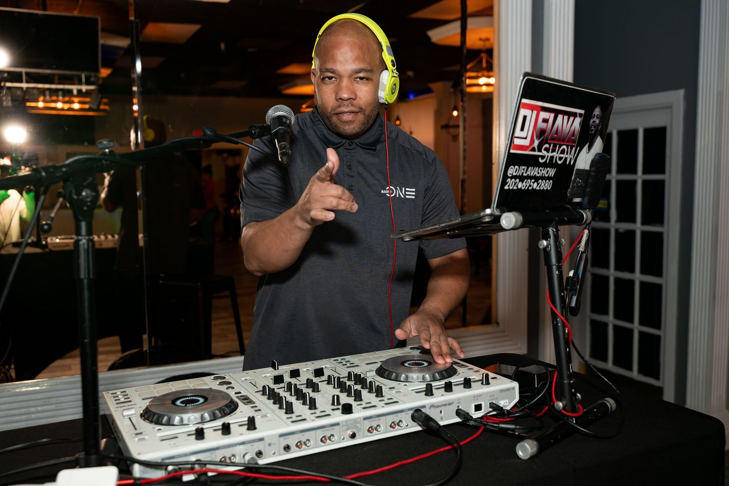 DJ equipment and mixing console setup at a nighttime event.