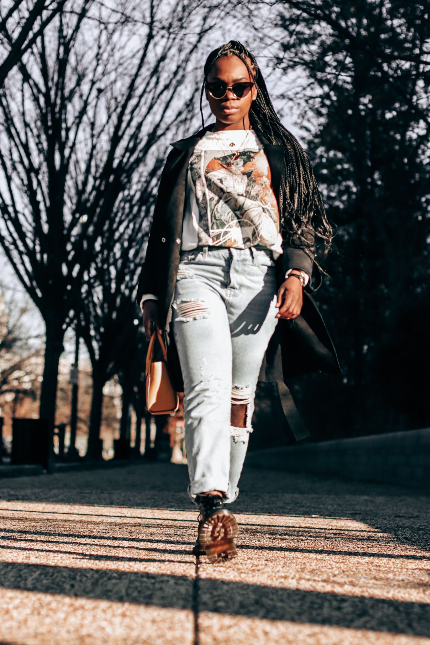 Stylish outdoor fashion photography with winter trees in background.
