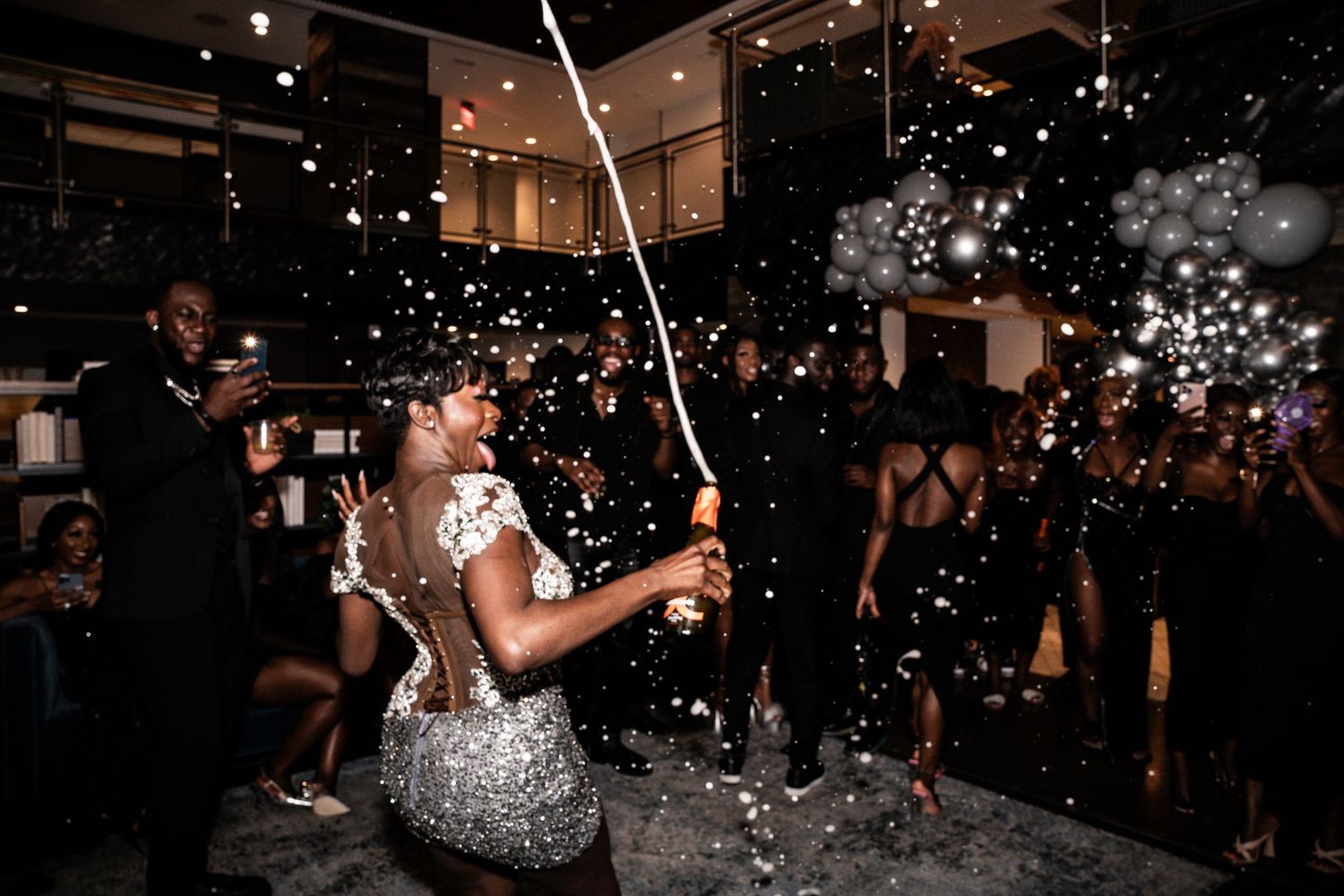 Dance party celebration with sparkling lights and festive atmosphere in dimly lit room.