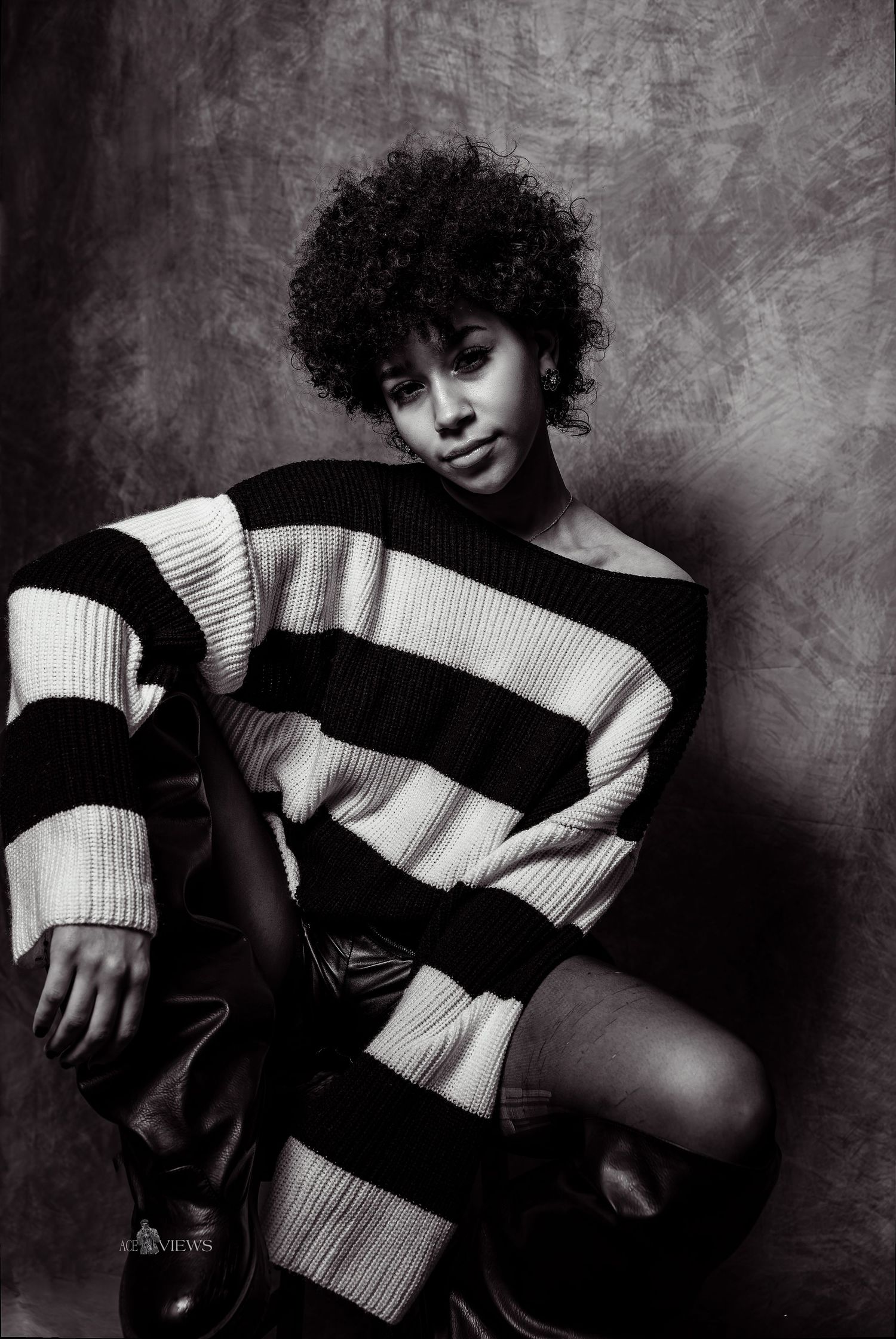 Artistic black and white portrait series featuring striped sweater and dynamic poses.