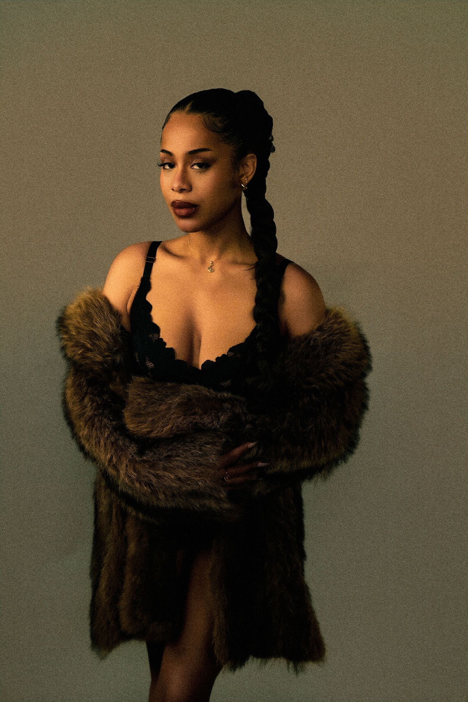 Fashion portraits featuring a brown fur wrap in moody lighting.