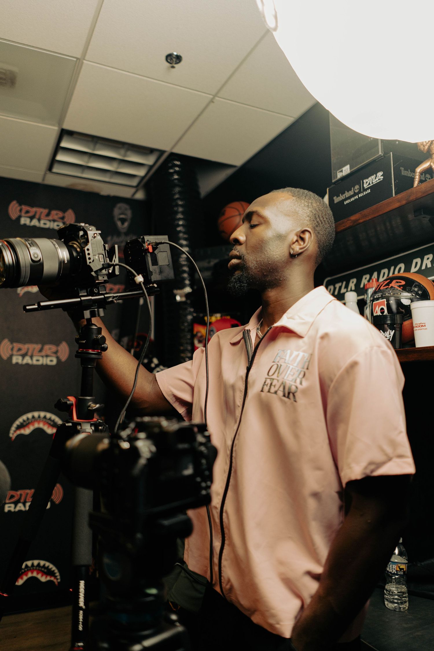 Behind the scenes of video production with camera equipment and lighting in studio setting.