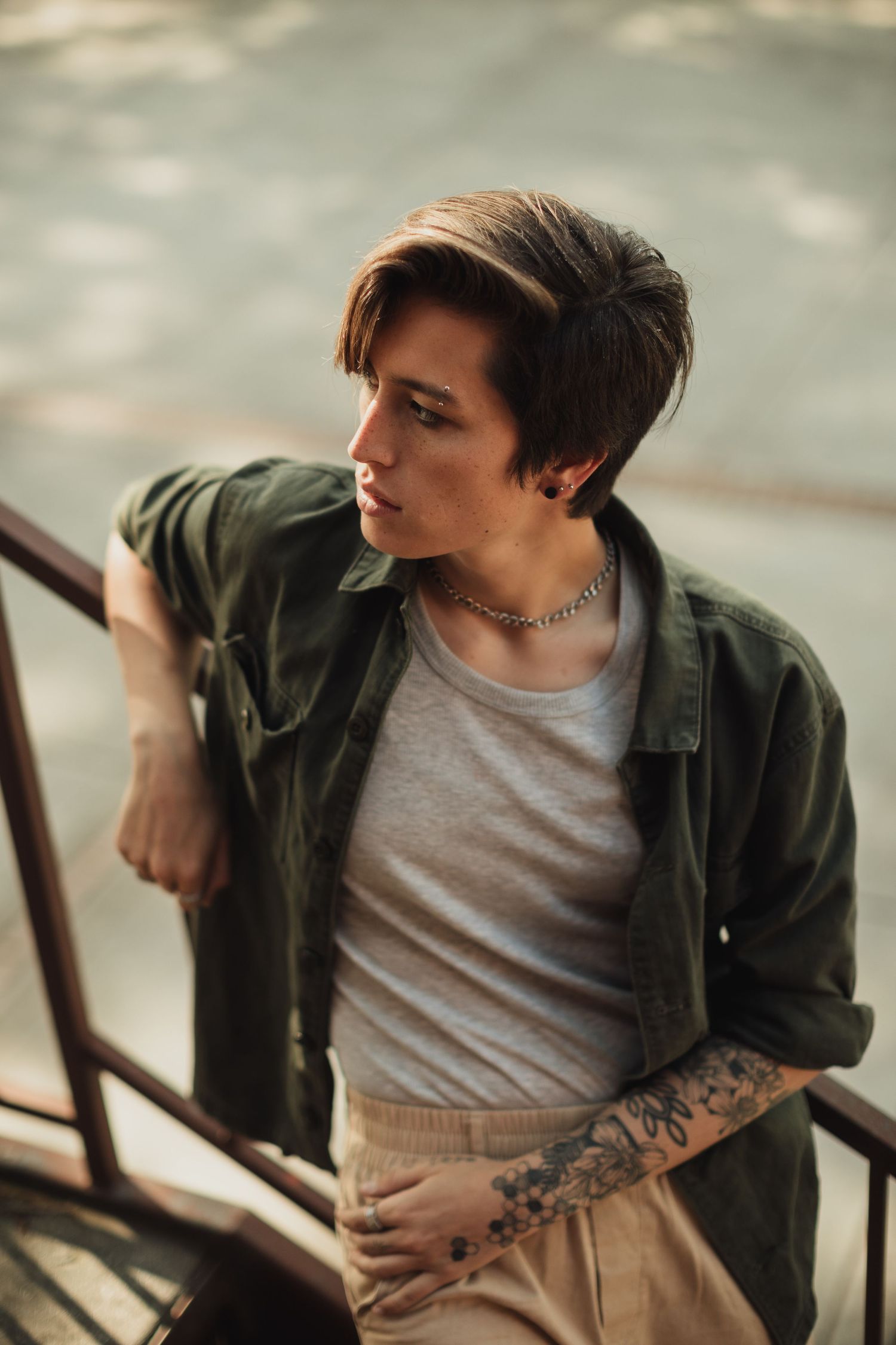 Artistic portrait series showing tattoos and layered casual fashion.