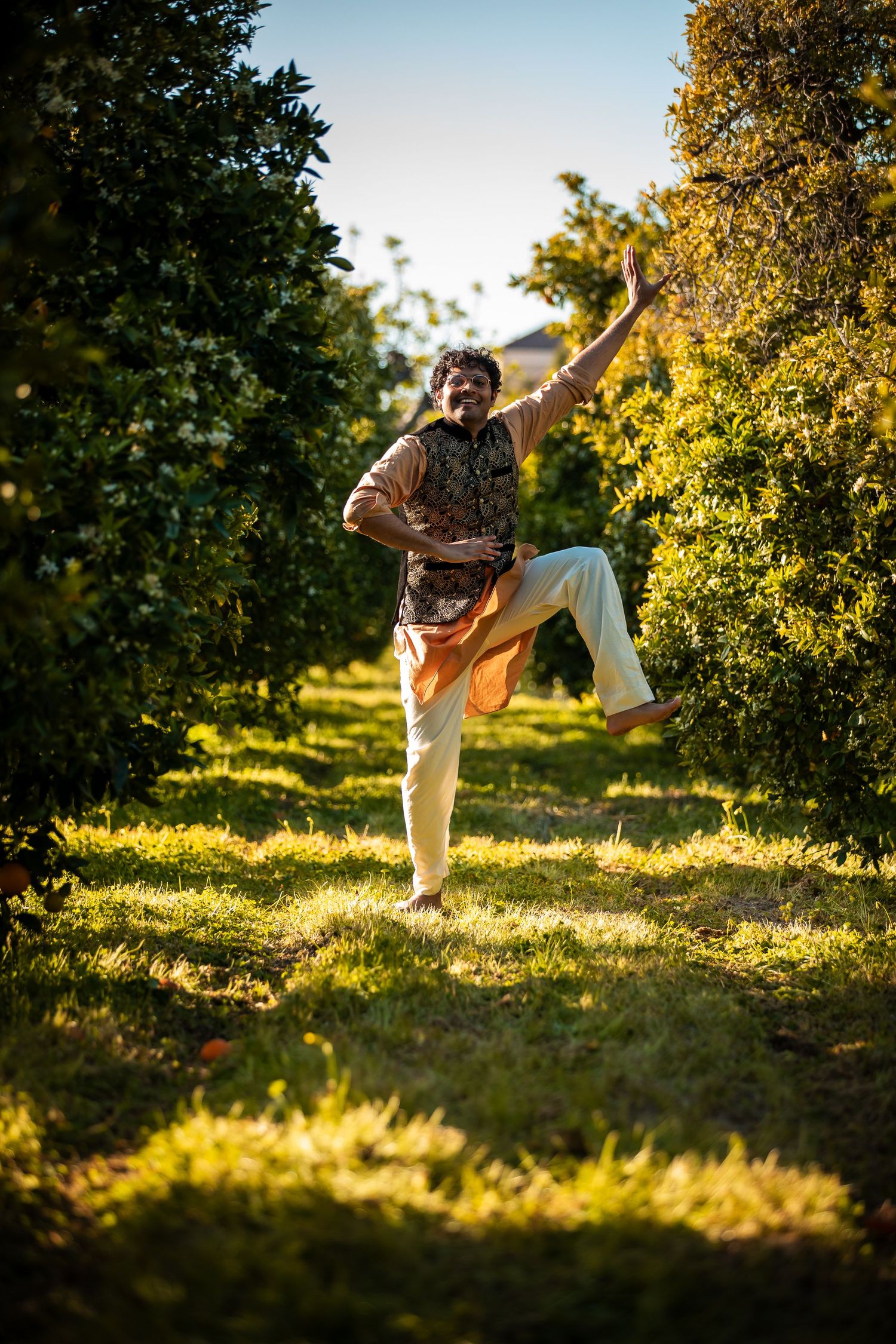 Dynamic dance movements captured in sunlit garden with yellow foliage.