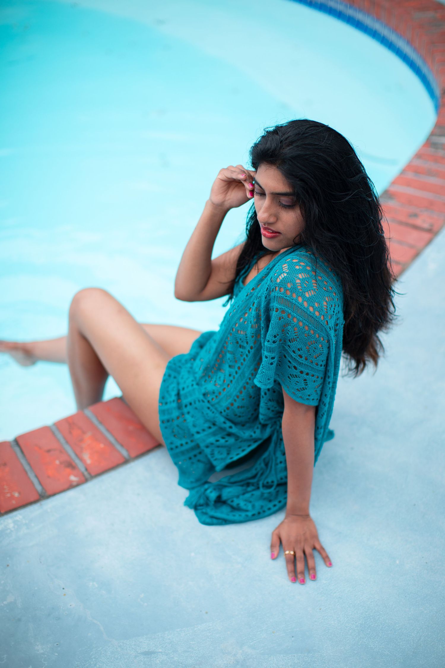 Poolside fashion photo featuring a turquoise crochet dress.