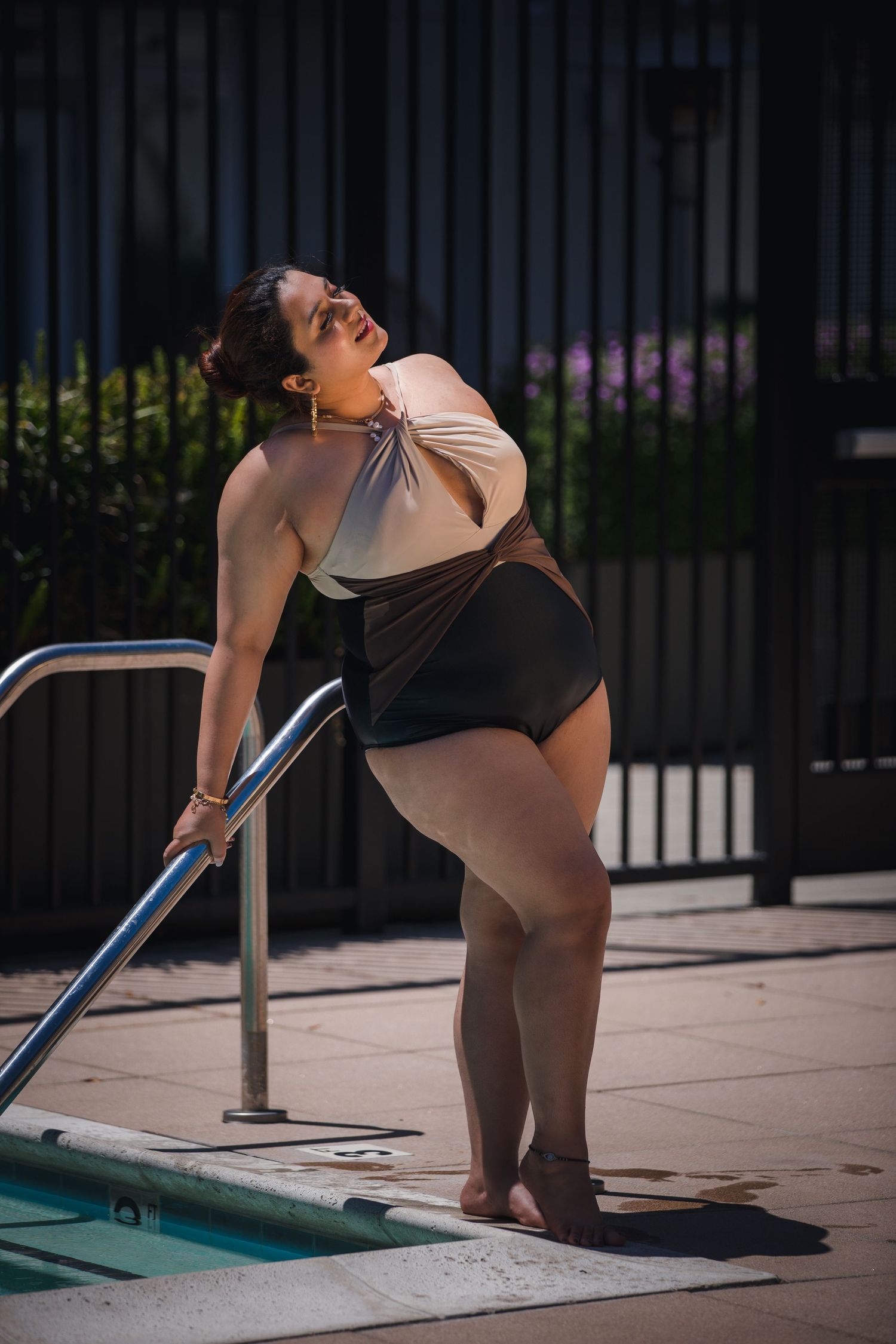 Candid poolside moment captured in swimwear and natural lighting.