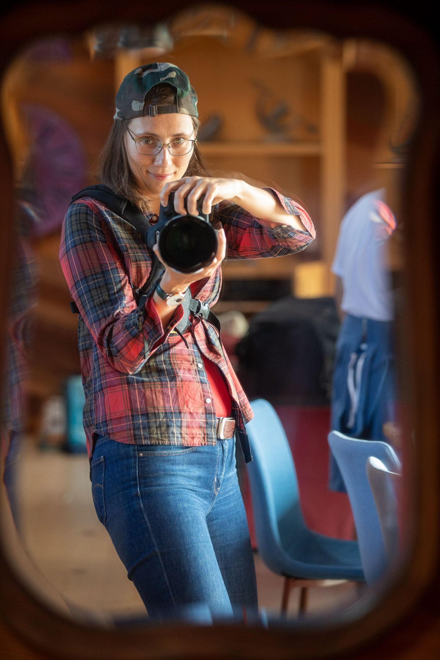 A person in a red plaid shirt and jeans demonstrates dance moves in a sequence of four connected photos.